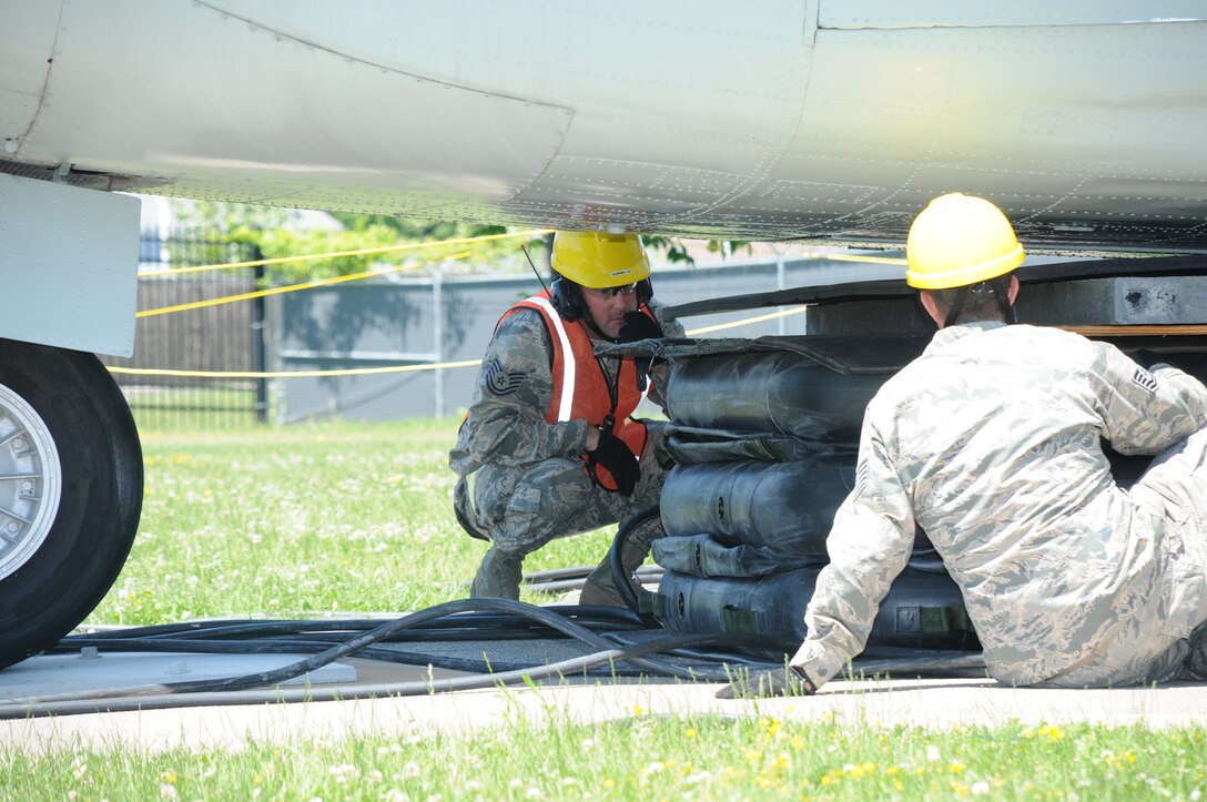 Tech. Sgt. Norman Green, 914th Maintenance Squadron, Crash Damaged and Disabled Aircraft Recover Team Chief, inspects pneumatic airbags with a member of the CDDAR team at Niagara Falls Air Reserve Station on June 6, 2015. Green led a team of more than 20 personnel through a simulated crash and recovery exercise. (U.S. Air Force photo by Staff Sgt. Matthew Burke)