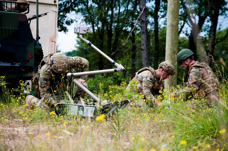 U.S. Air Force explosive ordnance disposal technicians led by MSgt. Shawn Lundgren, 446th Civil Engineer Squadron EOD technician, prepare their equipment to attempt a diffusion of a simulated improvised explosive device during the Patriot Warrior exercise at Fort McCoy, Wis., June 21, 2015. Patriot Warrior is a joint exercise designed to demonstrate contingency deployment training ranging from bare base buildup to full operational capabilities. It supports Exercise Global Lightning, a Combat Support Training Exercise (CSTX) including Global Medic 15 and Quartermaster Liquid Logistics Exercise 15 (QLLEX). Over 6,000 members from U.S. service components including Air Force, Army, and Navy (Active, Guard, and Reserve) participated alongside British and Canadian forces. (U.S. Air Force photo by Senior Airman Daniel Liddicoet/Released)