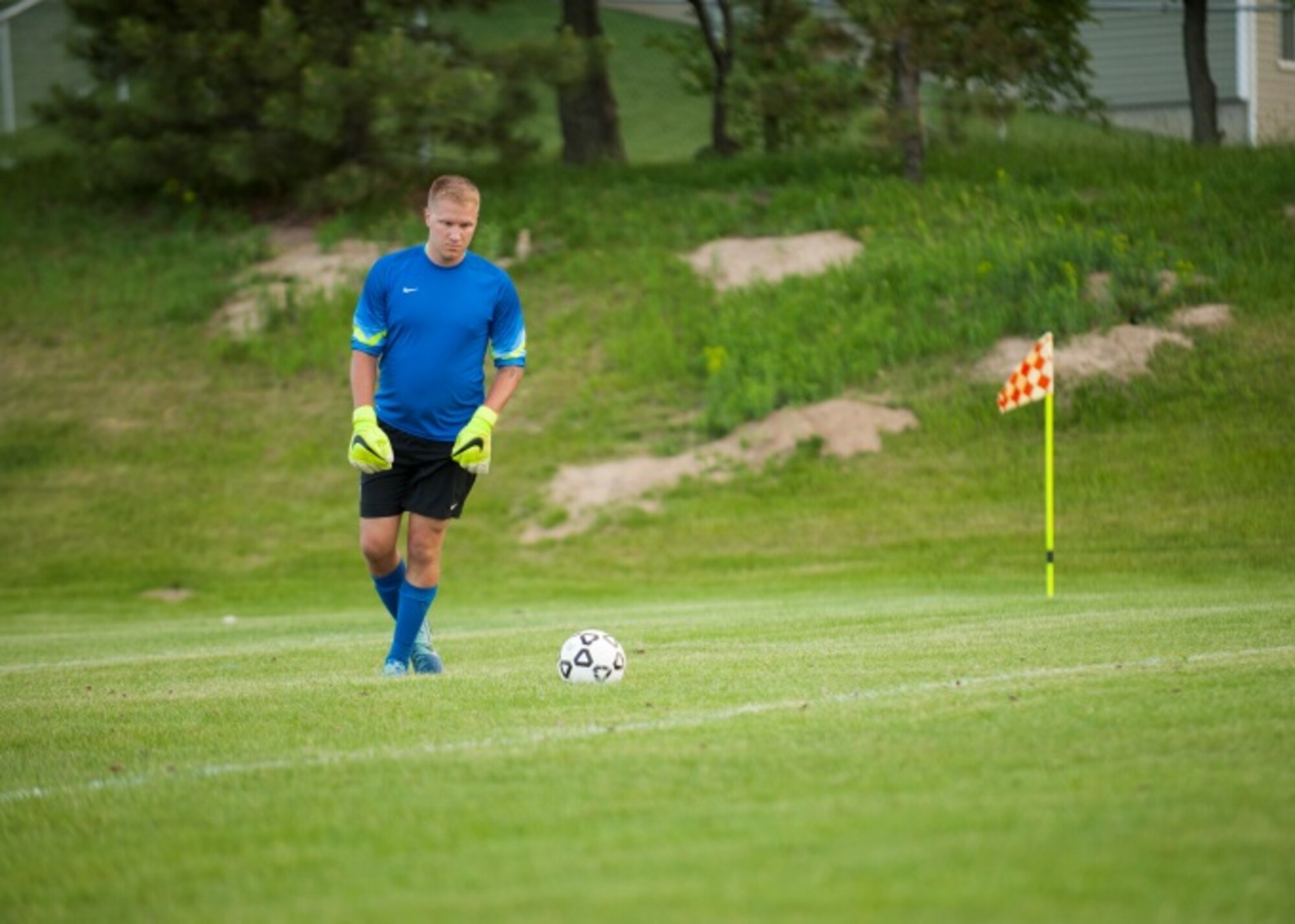 Senior Airman Ryan Praleikas, an aerospace medical technician with the 5th Medical Group, prepares to take a goal kick after stopping a shot attempt at Optimist Soccer Complex, Minot, N.D., June 17, 2015. Praleikas recently made the U.S. Air Force Men’s Soccer team. (U.S. Air Force photo/Airman 1st Class Christian Sullivan)