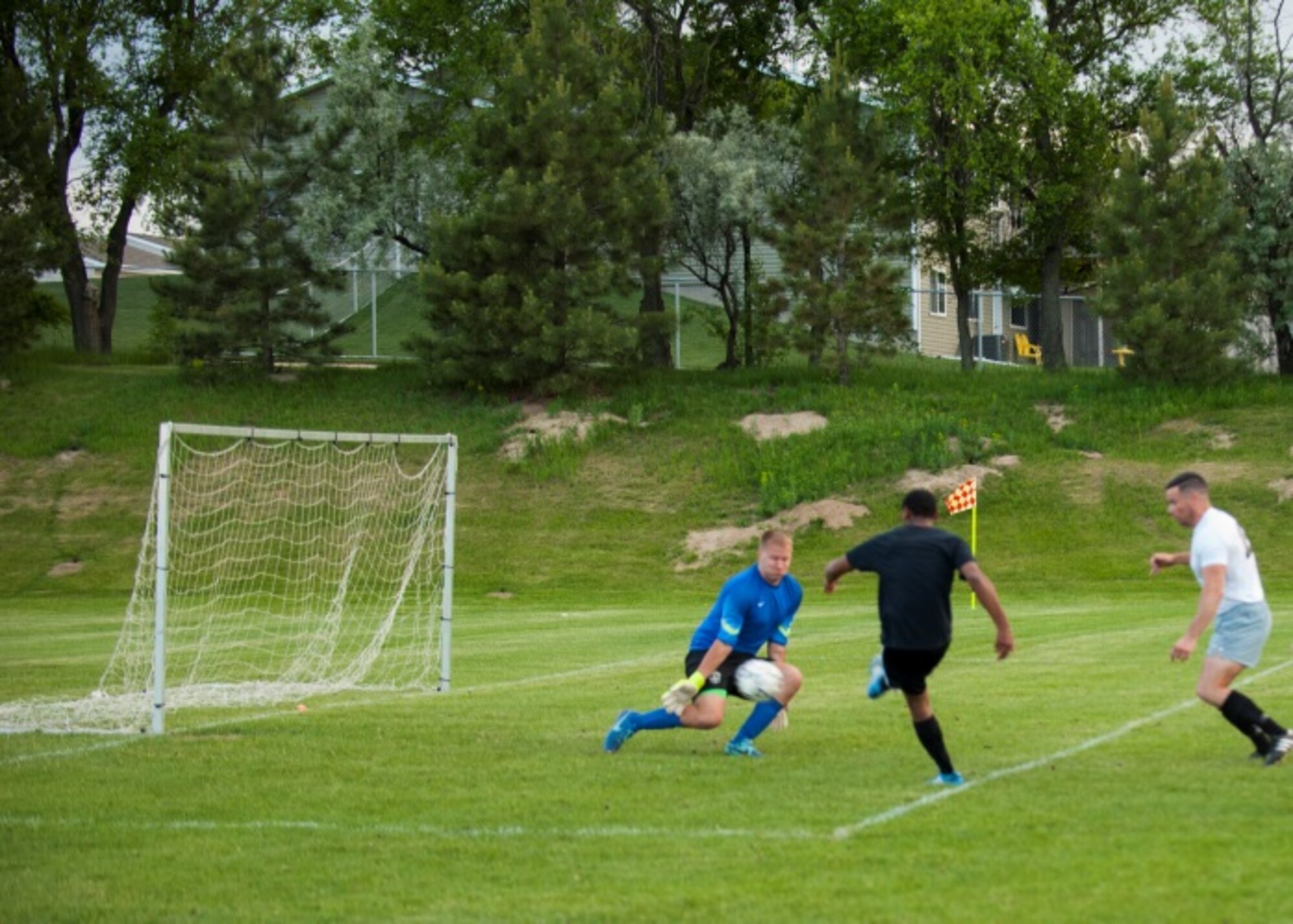 Senior Airman Ryan Praleikas, an aerospace medical technician with the 5th Medical Group, attempts to stop a shot from the opposing team at Optimist Soccer Complex, Minot, N.D., June 17, 2015. Praleikas was on the 2015 U.S. Air Force Men’s Soccer team when they took home silver in the All Armed Forces Tournament. (U.S. Air Force photo/Airman 1st Class Christian Sullivan)