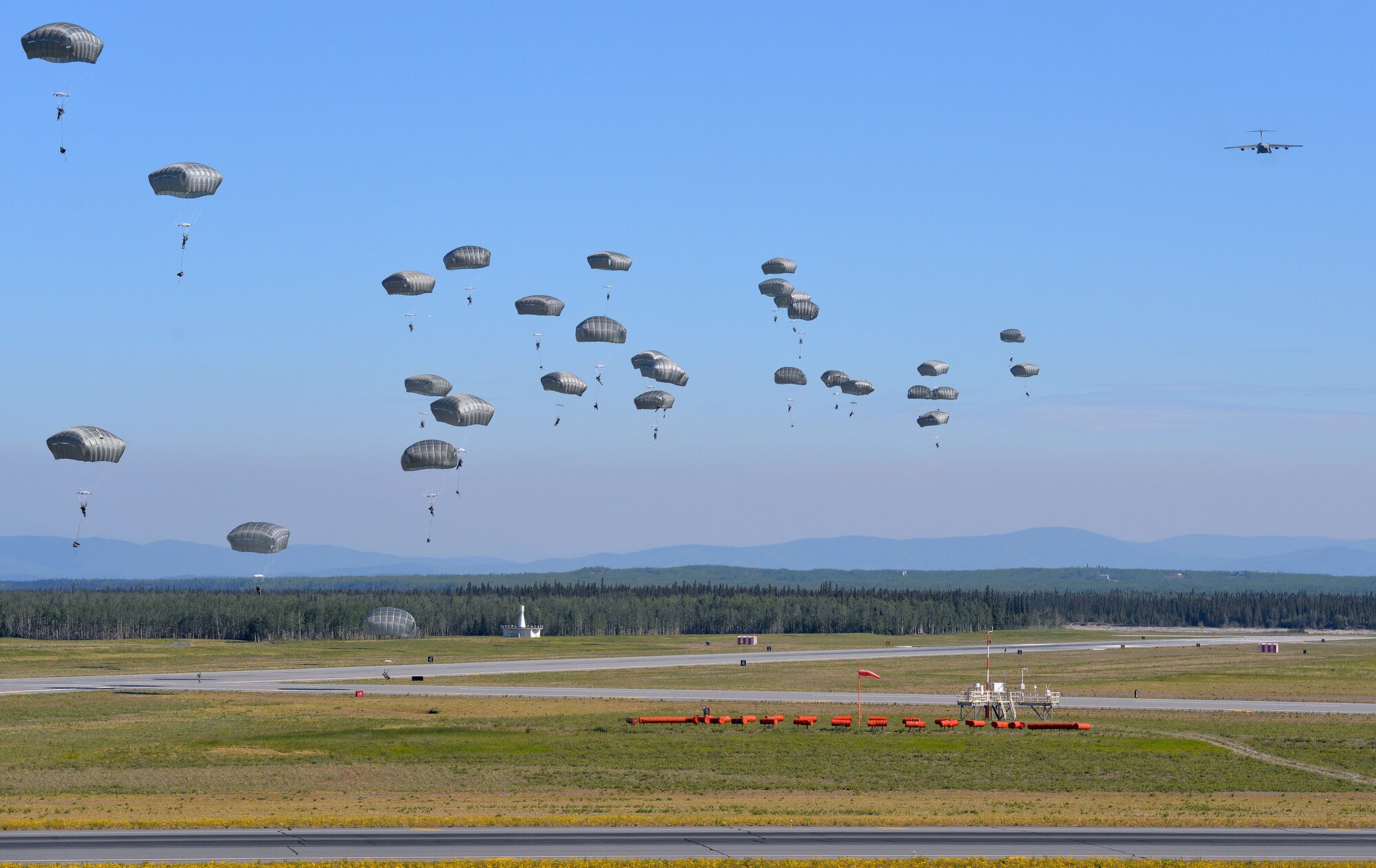U.S. Army engineers and combat engineers with the 6th Brigade Engineer Battalion, 4th Brigade Combat Team (Airborne), 25th Infantry Division, jump out of a U.S. Air Force C-17 Globemaster III aircraft into Allen Army Airfield at Fort Greely, Alaska, to execute airfield seizure operations as part of Exercise Northern Edge, June 17, 2015. Northern Edge 2015 is Alaska's premier joint training exercise designed to practice operations, techniques and procedures as well as enhance interoperability among the services. Thousands of Airmen, Soldiers, Sailors, Marines and Coast Guardsmen from active duty, reserve and National Guard units are involved. (U.S. Air Force photo by Master Sgt. Karen J. Tomasik/Released)