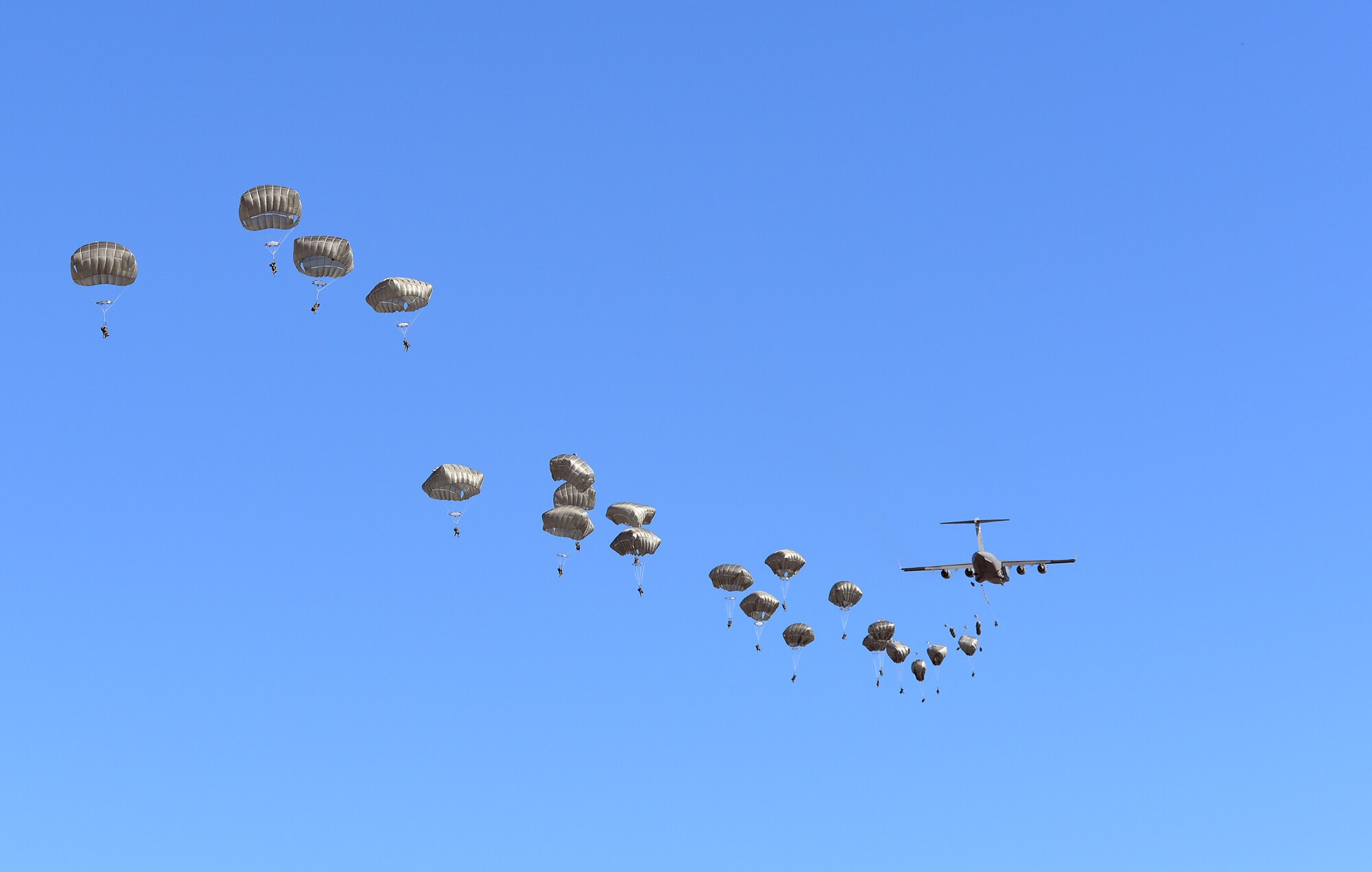 U.S. Army engineers and combat engineers with the 6th Brigade Engineer Battalion, 4th Brigade Combat Team (Airborne), 25th Infantry Division, jump out of a U.S. Air Force C-17 Globemaster III aircraft into Allen Army Airfield at Fort Greely, Alaska, to execute airfield seizure operations as part of Exercise Northern Edge, June 17, 2015. Northern Edge 2015 is Alaska's premier joint training exercise designed to practice operations, techniques and procedures as well as enhance interoperability among the services. Thousands of Airmen, Soldiers, Sailors, Marines and Coast Guardsmen from active duty, reserve and National Guard units are involved. (U.S. Air Force photo by Master Sgt. Karen J. Tomasik/Released)
