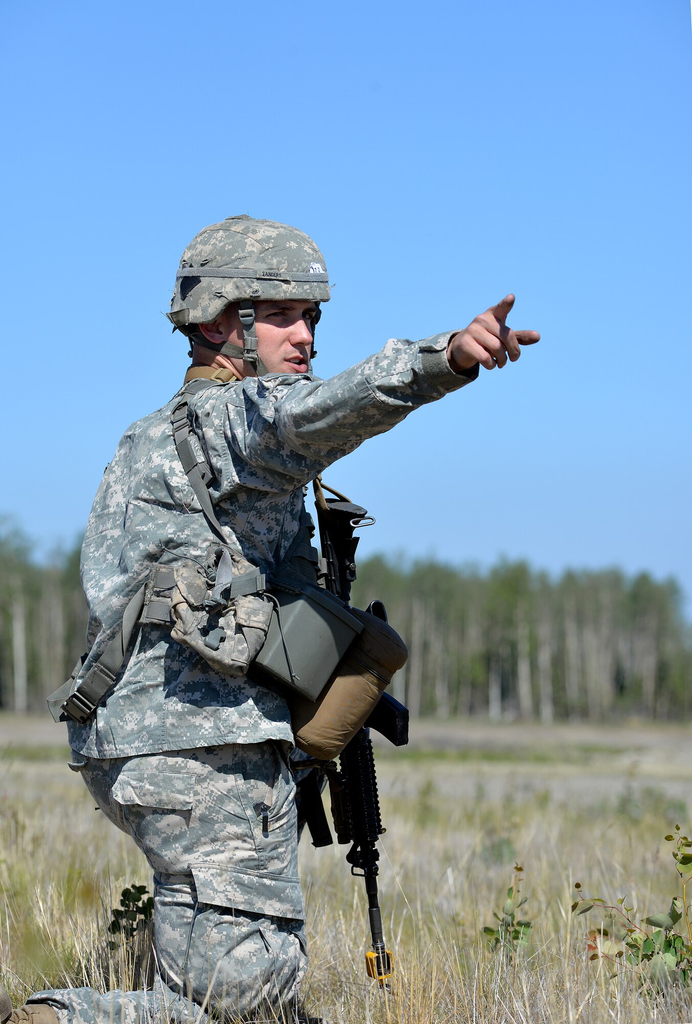 U.S. Army Sgt. Joshua Sanders, a Soldier with the 6th Brigade Engineer Battalion, 4th Brigade Combat Team (Airborne), 25th Infantry Division, directs members of his team to specific positions after detaining a team of opposing forces at Allen Army Airfield on Fort Greely, Alaska, as part of an airfield seizure scenario during Exercise Northern Edge, June 17, 2015. Northern Edge 2015 is Alaska's premier joint training exercise designed to practice operations, techniques and procedures as well as enhance interoperability among the services. Thousands of Airmen, Soldiers, Sailors, Marines and Coast Guardsmen from active duty, reserve and National Guard units are involved. (U.S. Air Force photo by Master Sgt. Karen J. Tomasik/Released)