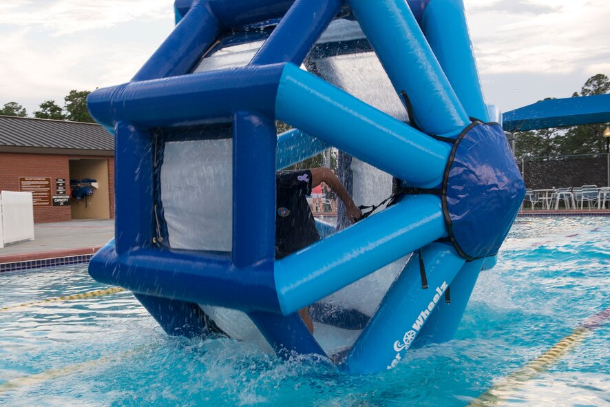 U.S. Air Force Airman 1st Class Reniro Viguilla, Aerospace Medical Squadron dental assistant, runs in a wheel for the Water Wheel Challenge June 18, 2015, at Moody Air Force Base, Ga. After the Build-a-Boat competition, Col. Chad Franks, 23d Wing commander, gave Airmen an opportunity to compete in the challenge for his parking spot for a week by beating his time of 49 seconds. Viguilla won the challenge for the second year in a row with a time of 34 seconds. (U.S. Air Force photo by Airman 1st Class Kathleen D. Bryant)