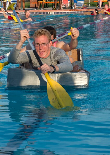 U.S. Air Force Airman 1st Class Kaelob King, 23d Civil Engineering Squadron explosive ordnance device apprentice, races down a swim lane during the Build-a-Boat competition June 18, 2015, at Moody Air Force Base, Ga. Airmen from the 23d CES won the competition with a time of two minutes and 10 seconds. (U.S. Air Force photo by Airman 1st Class Kathleen D. Bryant)
