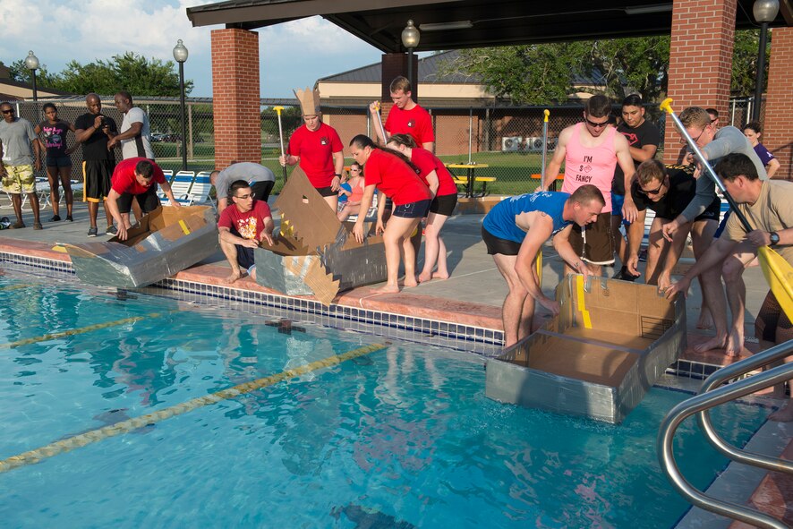 Three out of five teams prepare to race during the Build-a-Boat competition June 18, 2015, at Moody Air Force Base, Ga. The teams participated in a timed race at the outdoor pool for a trophy for their team. (U.S. Air Force photo by Airman 1st Class Kathleen D. Bryant)