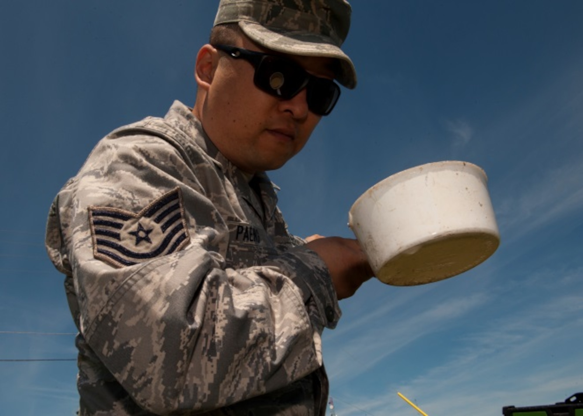 Tech. Sgt. Seung Paeng, noncommissioned officer in charge of pest management, tests standing water for mosquito larvae at Minot Air Force Base, N.D., June 18, 2015. By identifying where most of the insects lay their eggs, Paeng can more effectively prevent their breeding. (U.S. Air Force photo/Airman 1st Class Christian Sullivan)