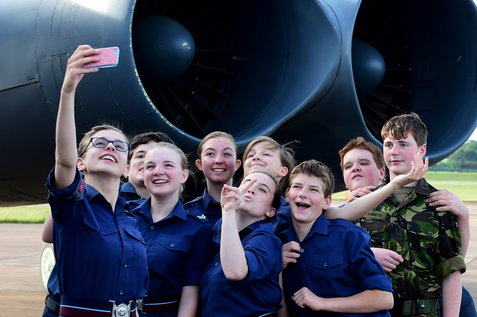 British Air Cadets from 614 and 1245 Air Training Squadrons, pose for a group selfie at a B-52H Stratofortress at RAF Fairford, United Kingdom, June 16, 2015. The Air Cadets had the opportunity to see the B-52H up close and ask the crew questions. The B-52H is forward-deployed to RAF Fairford in support of the BALTOPS 15 and SABER STRIKE 15 exercises. (U.S. Air Force photo by Tech. Sgt. Chrissy Best)