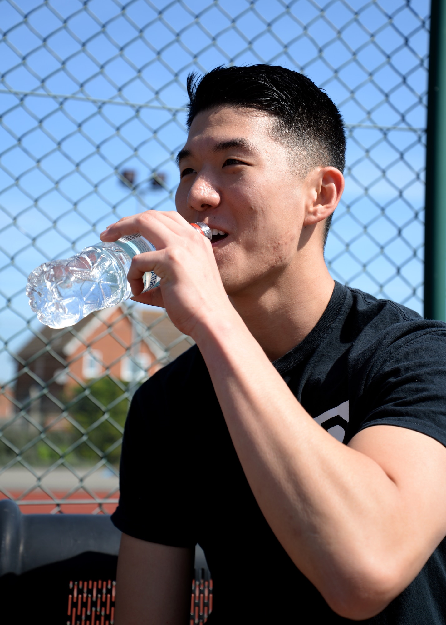U.S. Air Force 2nd Lt. Michael Joo, 100th Air Refueling Wing protocol officer from Houston, Texas, hydrates after a soccer match June 11, 2015, on RAF Mildenhall. Joo stayed healthy and safe by hydrating throughout the game. (U.S. Air Force photo by Senior Airman Kyla Gifford/Released) 
