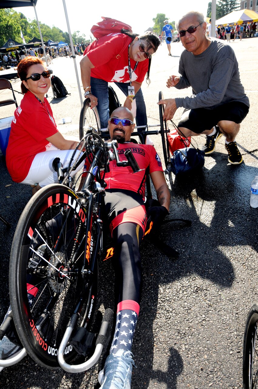 Medically retired Marine Corps Staff Sgt. Ronnie Jeffrey Jimenez, center, celebrates with his wife, Patrice Jimenez, left, and his parents, Mary Ann and Ronnie Jimenez, after he earned a gold medal in the men's H5 hand cycle category at the 2015 DoD Warrior Games on Marine Corps Base Quantico, Va., June 21, 2015. DoD photo by Shannon Collins