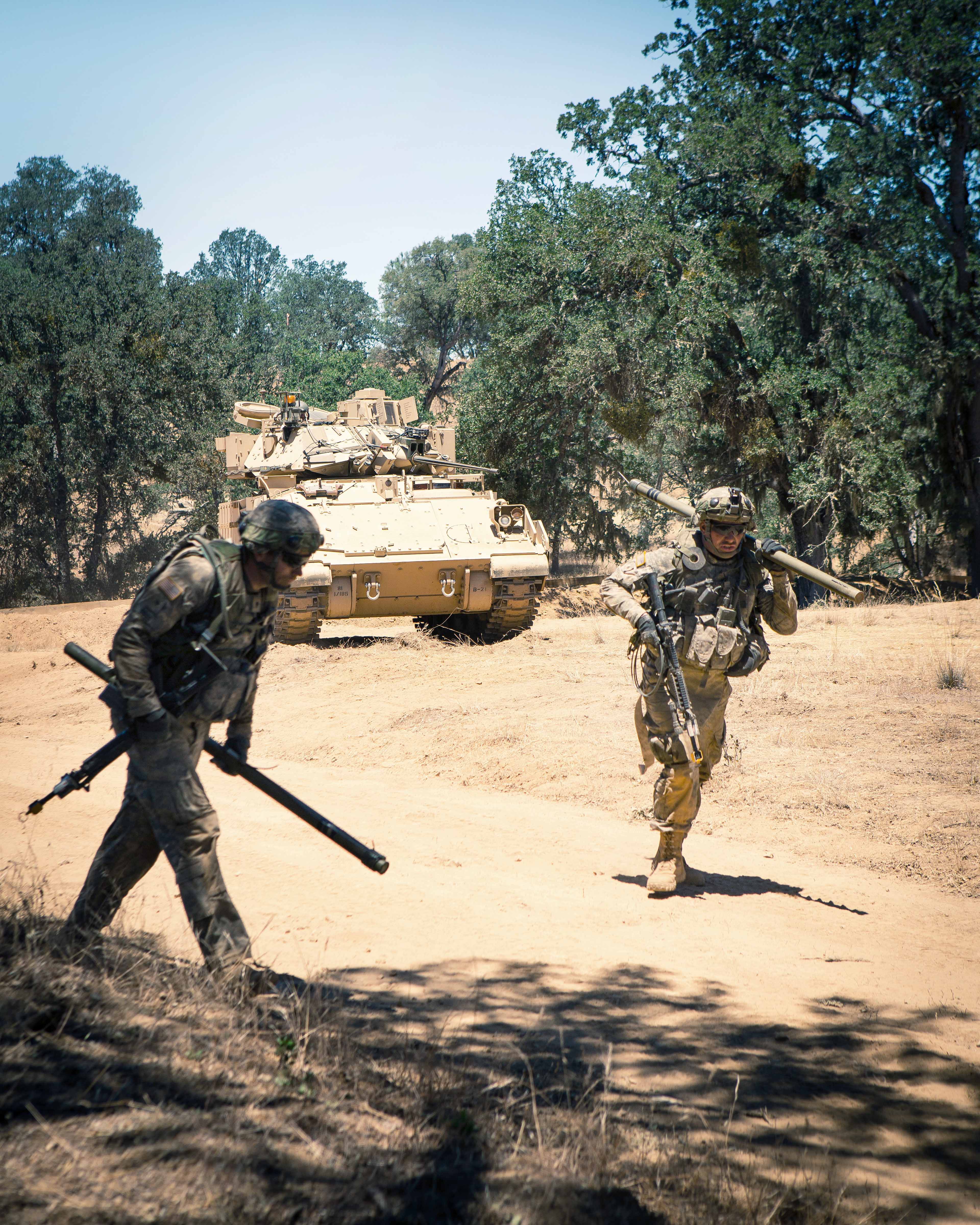 Soldiers bring up bangalore torpedos, which are explosive charges on