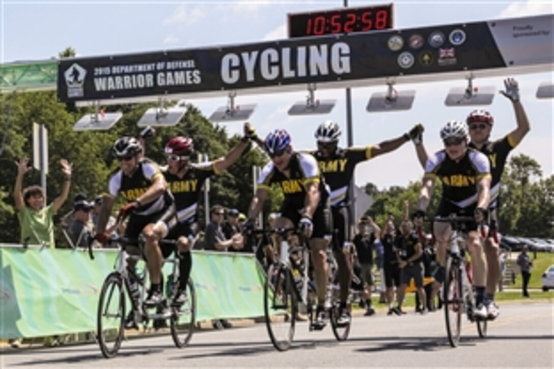 U.S. Army athletes cross the finish line during a tandem cycling competition at the 2015 Department of Defense Warrior Games on Marine Corps Base Quantico, Va., June 21, 2015. 