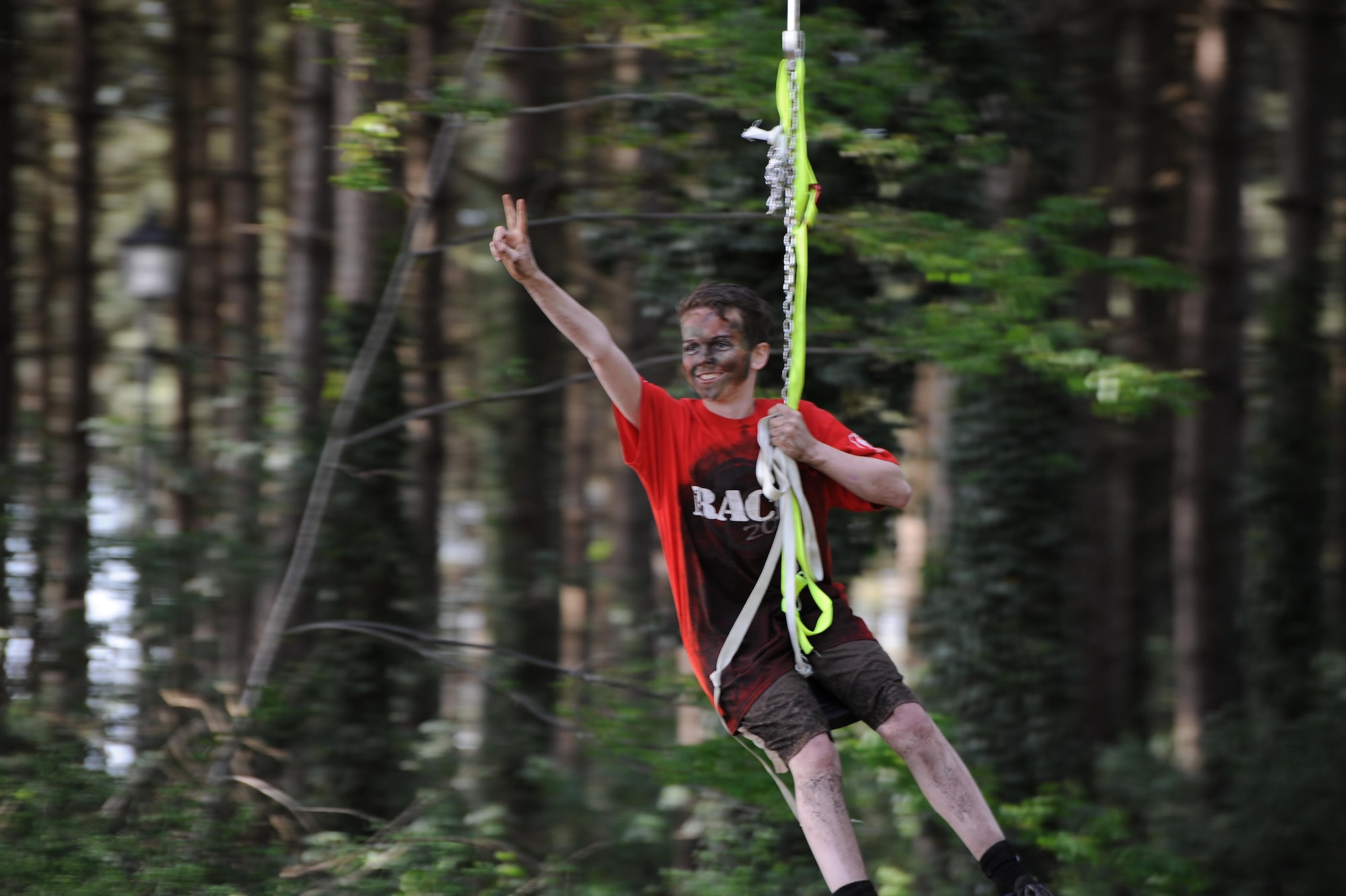 A son zip lines through the wooded area during the “Momster Mash” May 16, 2015, at the Heritage Park sports fields on RAF Mildenhall, England. The event was hosted by the 352nd Special Operations Wing Preservation of Force and Families team and was aimed at providing an opportunity for mothers and their sons – traditionally a relationship with difficulties -- to bond. (U.S. Air Force photo by Tech. Sgt. Stacia Zachary)