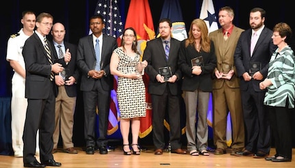 WASHINGTON (June 12, 2015) - Sean J. Stackley, assistant secretary of the Navy for research, development, and acquisition, is joined by Dr. Delores M. Etter as he recognizes the Laser Weapon System (LaWS) engineering team from the Naval Surface Warfare Center Dahlgren Division (NSWCDD) during the 2014 Dr. Delores M. Etter Top Scientists and Engineers Awards ceremony at the Pentagon. LaWS is a collaborative effort between the Office of Naval Research, Naval Sea Systems Command, U.S. Naval Research Laboratory and NSWC-DD. The system deployed aboard USS Ponce in the Persian Gulf in 2014.