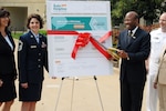 Dr. Clifford L. Stanley, undersecretary of defense for personnel and 
readiness, Department of Defense, cuts the ribbon, officially announcing the 
DoD Safe Helpline for sexual assault support at the Pentagon April 15, 2011. 
The event followed an award ceremony that recognized the top sexual assault 
response coordinator from each of the active duty services, including National 
Guard member, Senior Master Sgt. Kelly Wilkinson (left), Minnesota National 
Guard.