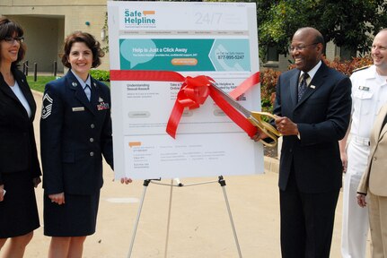 Dr. Clifford L. Stanley, undersecretary of defense for personnel and 
readiness, Department of Defense, cuts the ribbon, officially announcing the 
DoD Safe Helpline for sexual assault support at the Pentagon April 15, 2011. 
The event followed an award ceremony that recognized the top sexual assault 
response coordinator from each of the active duty services, including National 
Guard member, Senior Master Sgt. Kelly Wilkinson (left), Minnesota National 
Guard.