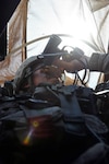 Spc. John York, an M240B gunner and a Tulsa, Okla., native with Bravo Company, 163rd Combined Arms Battalion, 1st Infantry Regiment, 4th Sustainment Brigade, 310th Expeditionary Sustainment Command, looks out his gunnerâ€™s hatch during a convoy escort and security mission March 29. The 163rd CABâ€™s escort teams have been conducting convoy escort missions in support of Operation New Dawn since November. 