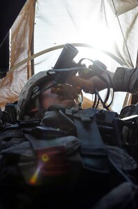 Spc. John York, an M240B gunner and a Tulsa, Okla., native with Bravo Company, 163rd Combined Arms Battalion, 1st Infantry Regiment, 4th Sustainment Brigade, 310th Expeditionary Sustainment Command, looks out his gunnerâ€™s hatch during a convoy escort and security mission March 29. The 163rd CABâ€™s escort teams have been conducting convoy escort missions in support of Operation New Dawn since November. 