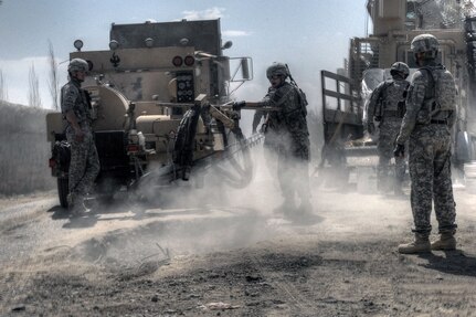 Improving driving conditions for local citizens, Soldiers of 1st Platoon,
118th Sappers, repair a road near Yaqubi Village, Khowst Province,
Afghanistan, March 24, 2011.