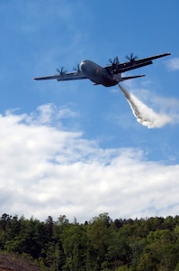 A C-130 from the 146th Airlift Wing located in Port Hueneme, Calif. drops water over the treetops in South Carolina. Modular Airborne Fire Fighting System, known as MAFFS, commenced annual training and certification this week in Greenville, S.C. April 26 to April 30, 2010. Photo by Airman 1st Class Nicholas Carzis
