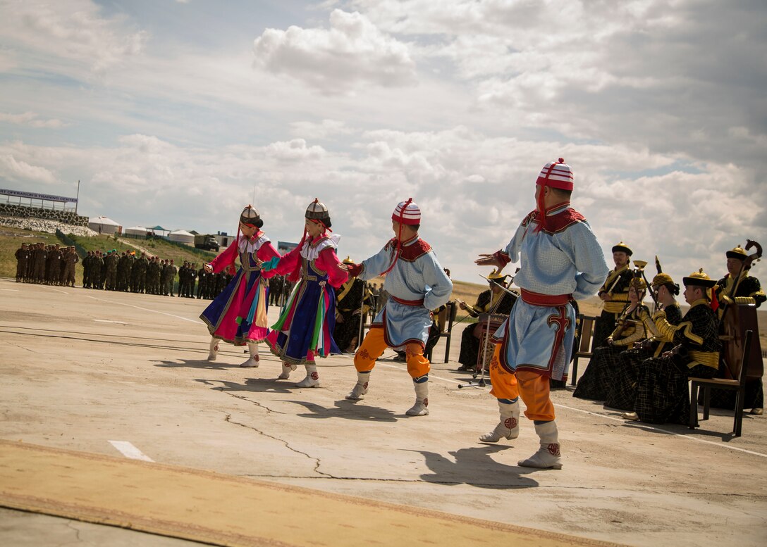 The Mongolian Military Dance and Song Ensemble performs a traditional Mongolian dance for service members of participating nations during the opening ceremonies of Khaan Quest 2015, in Tavantolgoi, Mongolia, June 20, 2015. Khaan Quest is a regularly scheduled, multinational exercise hosted annually by Mongolian Armed Forces and co-sponsored by U.S. Army, Pacific, and U.S. Marine Corps Forces, Pacific. KQ15 is the latest in a continuing series of exercises designed to promote regional peace and security. This year marks the 13th iteration of this training event. 
