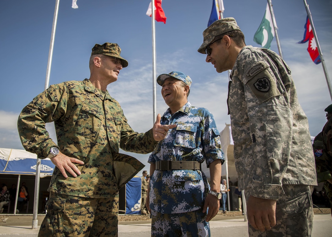 Brig. Gen. Christopher J. Mahoney, left, deputy commander, U.S. Marine Corps Forces, Pacific, converses with Senior Col. Bao Yu Hai, Chinese Army, middle, and U.S. Army Col. Christopher DiCicco, right, U.S. defense attache to Mongolia, before the opening ceremonies of Khaan Quest 2015, in Tavantolgoi, Mongolia, June 20, 2015. Khaan Quest is a regularly scheduled, multinational exercise hosted annually by Mongolian Armed Forces and co-sponsored by U.S. Army, Pacific, and U.S. Marine Corps Forces, Pacific. KQ15 is the latest in a continuing series of exercises designed to promote regional peace and security. This year marks the 13th iteration of this training event.