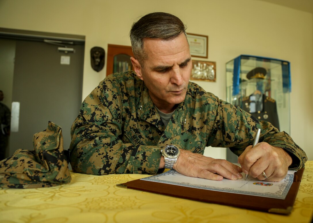 Brig. Gen. Christopher J. Mahoney, deputy commander, U.S. Marine Corps Forces, Pacific, signs the guest book in the Maj. Gen. Ragchaa Gur Memorial Room at the Peacekeeping Support Operations Center during Khaan Quest 2015 in Tavantolgoi, Mongolia, June 22, 2015. Khaan Quest is a regularly scheduled, multinational exercise hosted annually by Mongolian Armed Forces and co-sponsored by U.S. Army, Pacific, and U.S. Marine Corps Forces, Pacific. KQ15 is the latest in a continuing series of exercises designed to promote regional peace and security. This year marks the 13th iteration of this training event.