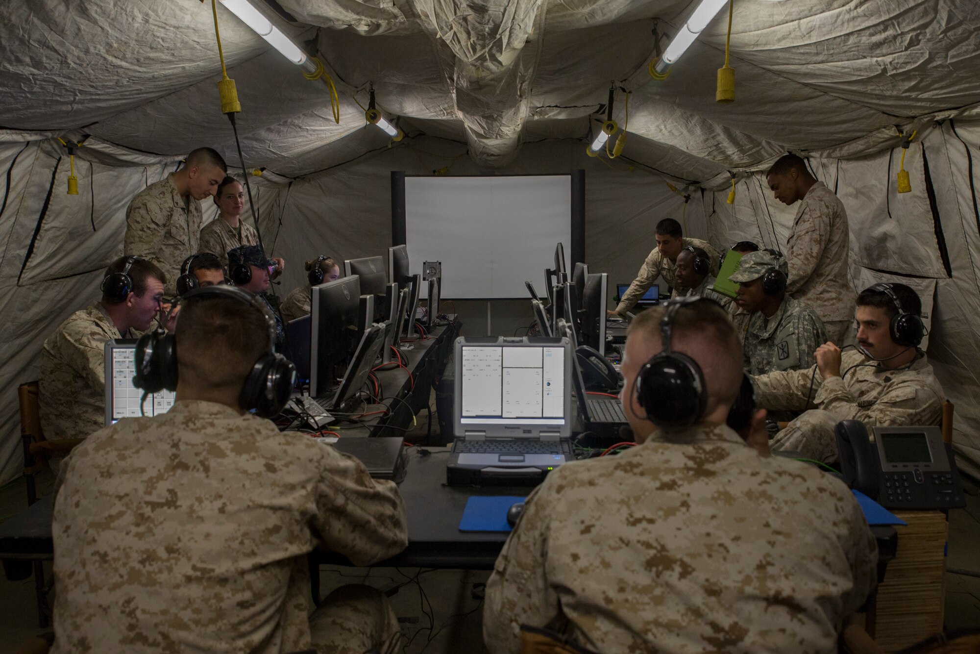EIELSON AIR FORCE BASE, Alaska – U.S. Marines, Sailors, Airmen and Soldiers work together at an operations center in the Joint Pacific Alaska Range Complex to de-conflict large force launch and recovery of aircraft during Exercise Northern Edge, June 17, 2015. Northern Edge 2015 is Alaska’s premier joint training exercise designed to practice operations, techniques and procedures as well as enhance interoperability among the services. Thousands of airmen, soldiers, sailors Marines and Coast Guardsmen from active duty, reserve and National Guard Units are involved. (U.S. Marine Corps photo by Cpl. Thor J. Larson/Released)