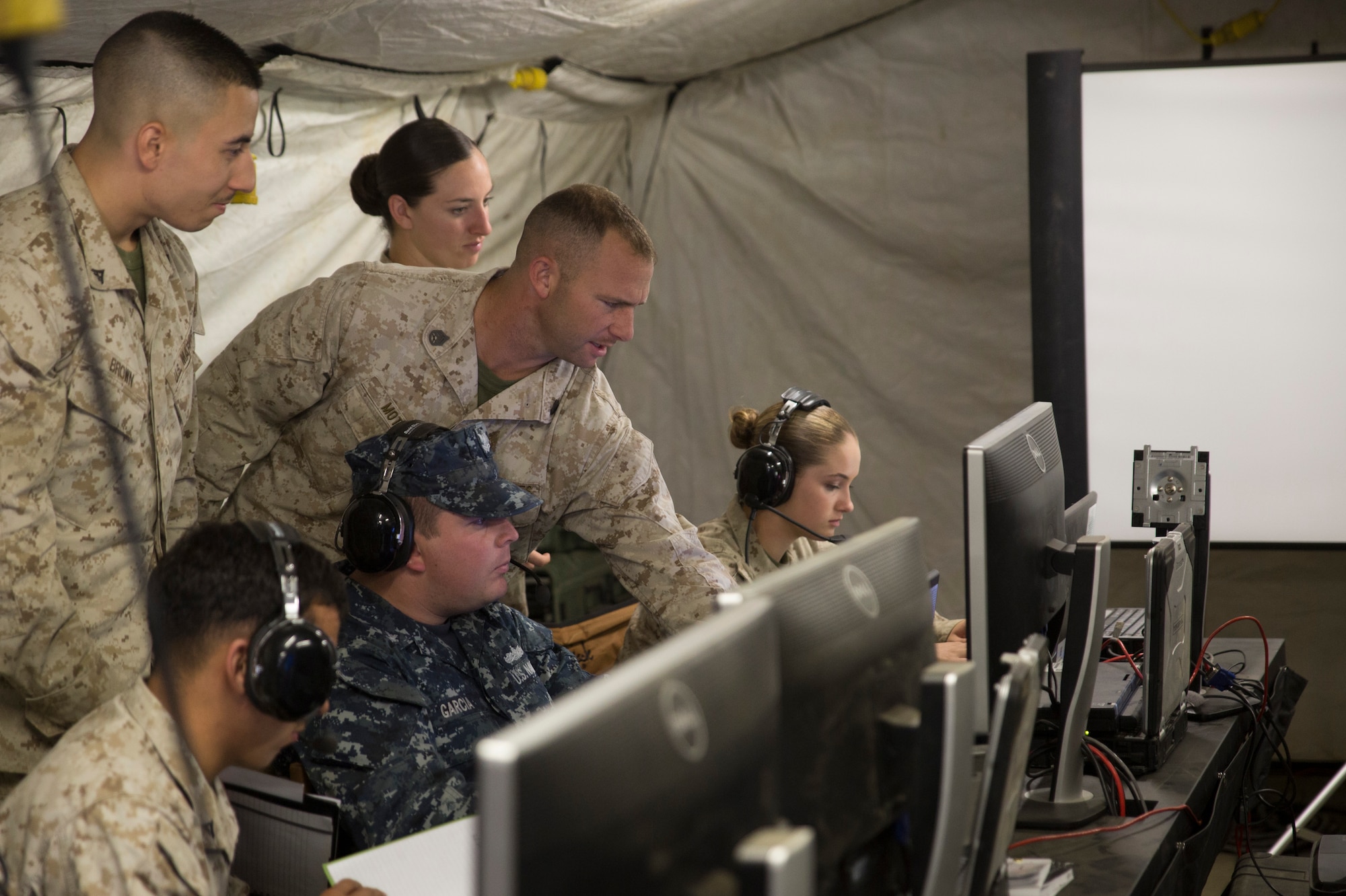 EIELSON AIR FORCE BASE, Alaska – U.S. Marines, Sailors, Airmen and Soldiers work together at an operations center in the Joint Pacific Alaska Range Complex to de-conflict large force launch and recovery of aircraft during Exercise Northern Edge, June 17, 2015. Northern Edge 2015 is Alaska’s premier joint training exercise designed to practice operations, techniques and procedures as well as enhance interoperability among the services. Thousands of airmen, soldiers, sailors Marines and Coast Guardsmen from active duty, reserve and National Guard Units are involved. (U.S. Marine Corps photo by Cpl. Thor J. Larson/Released)