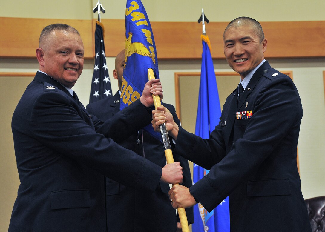 Lt. Col. Daniel Castigilia, right, accepts command of the 341st Medical Support Squadron from Col. Christopher Phillips, 341st Medical Group commander, June 22 at the Grizzly Bend. (U.S. Air Force photo/John Turner)