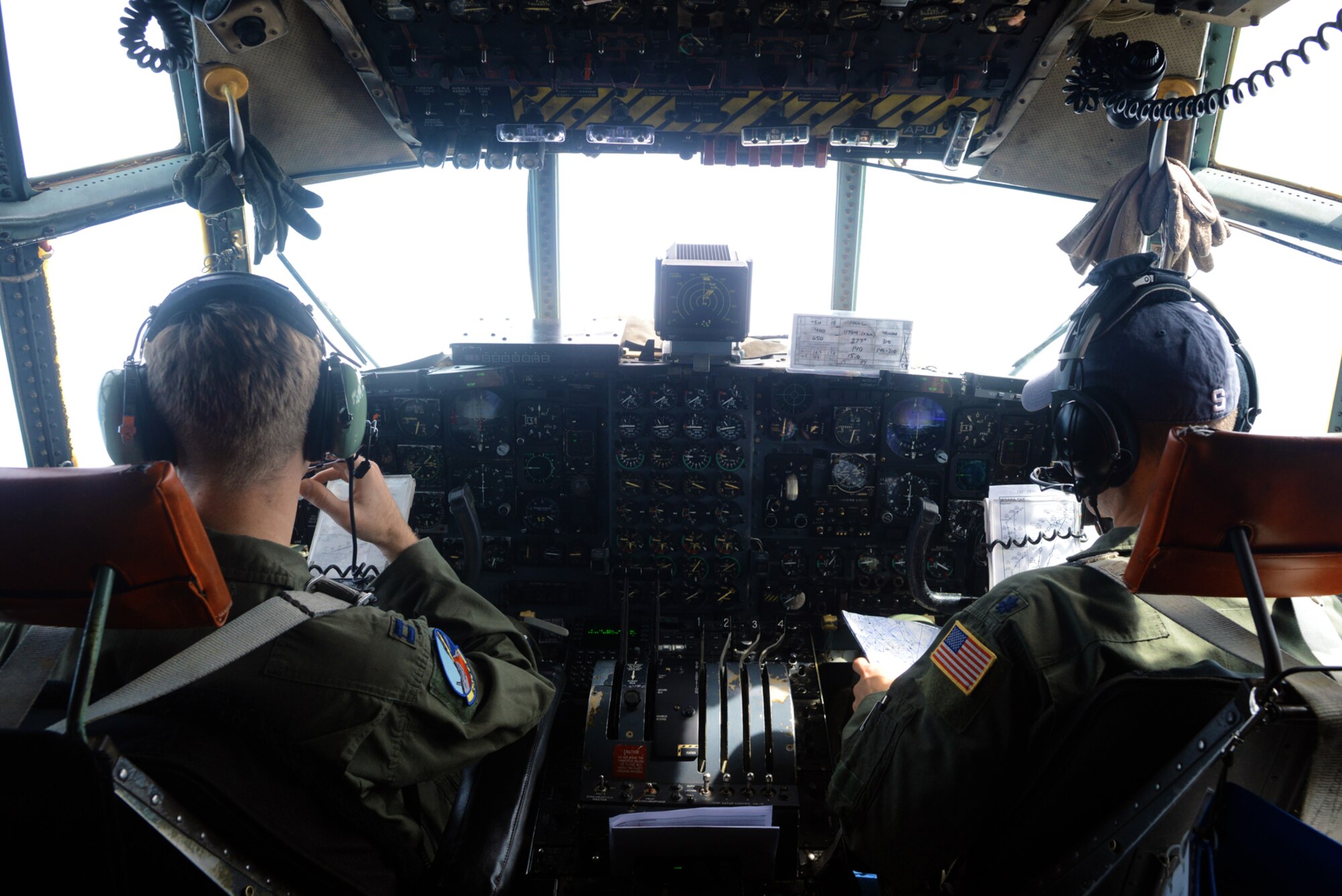 Capt. Michael Kelly, left, 374th Operations Support Squadron, and Lt. Col. John R. Kerr, 36th Airlift Squadron director of operations, fly a C-130 Hercules during a training exercise in the skies above Japan, June 19, 2015. During the flight, pilots were required to simulate dropping cargo with limited visibility.    