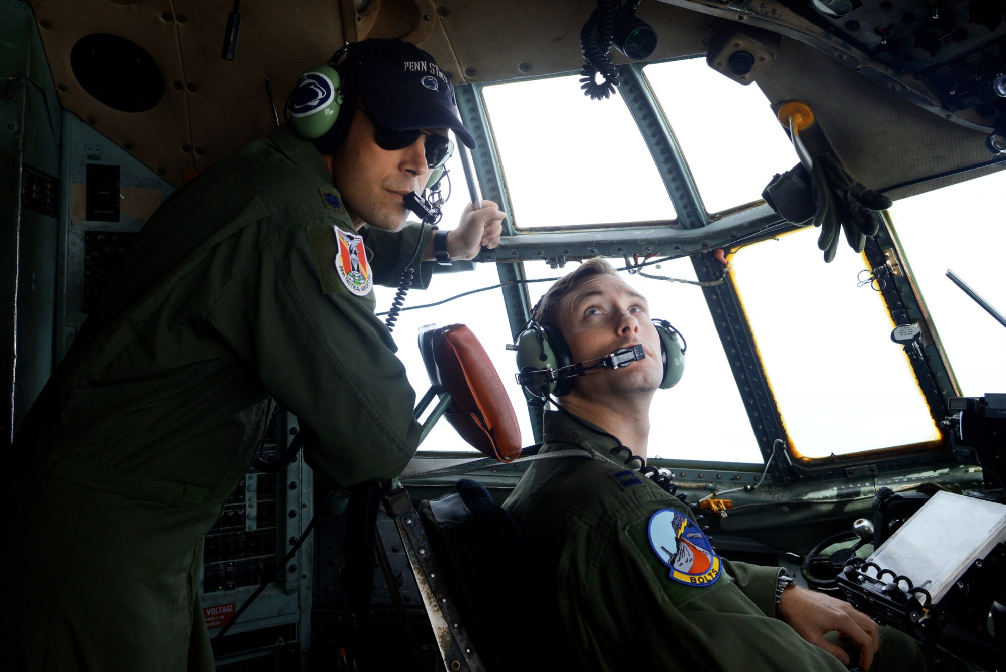 Lt. Col. Andrew J. Campbell, 36th Airlift Squadron commander, observes pilot Capt. Michael Kelly, 374th Operations Support Squadron assistant training flight commander, during a training exercise, June 19, 2015. The flight helped certify Misawa Air Base’s new drop zone, in which the C-130H can simulate dropping cargo with limited visibility.  