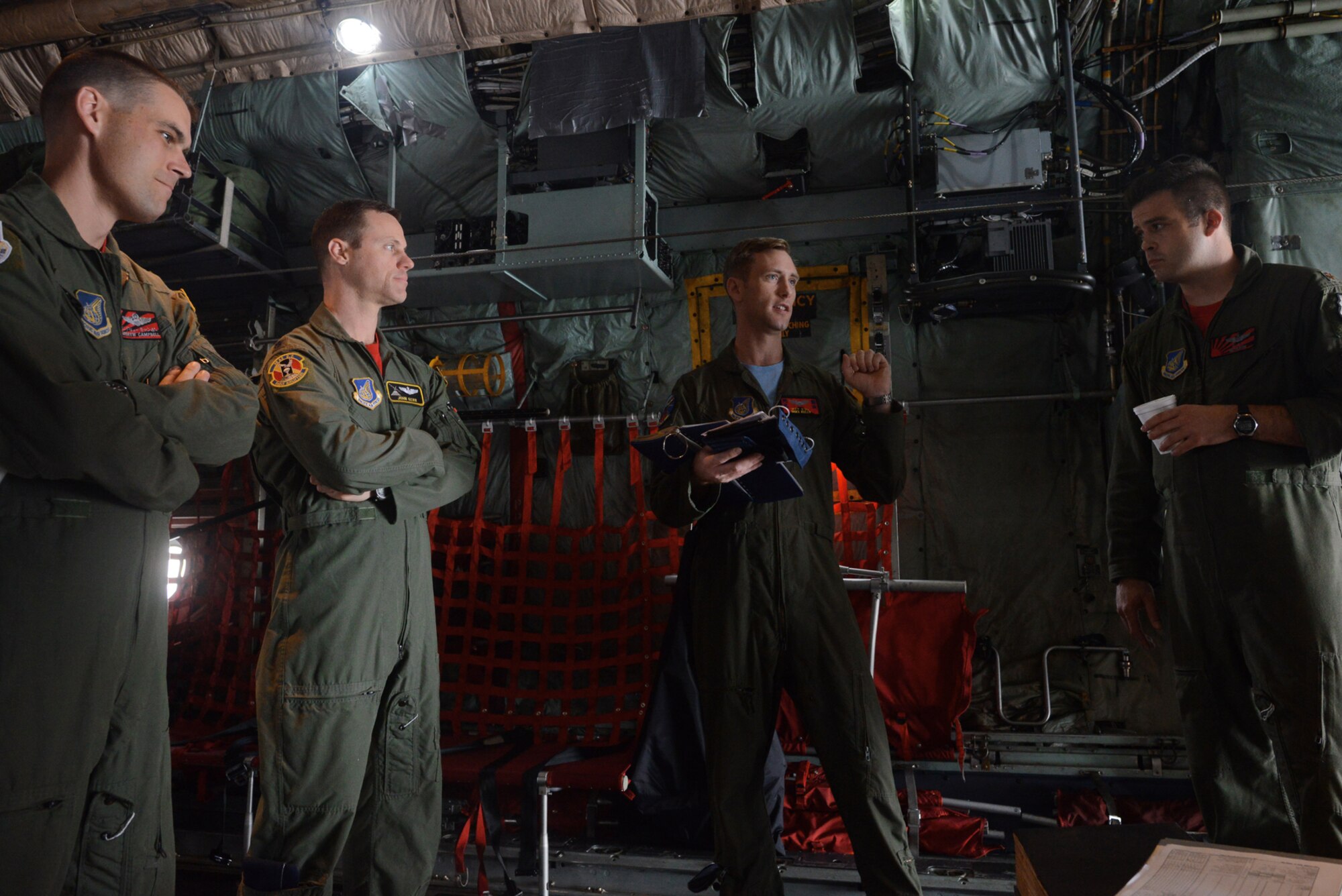 Pilots from the 374th Operations Group receive a brief for a training exercise, June 19, 2015, at Yokota Air Base, Japan. The flight tested the capabilities of a new drop zone courtesy of Misawa Air Base, Japan. 