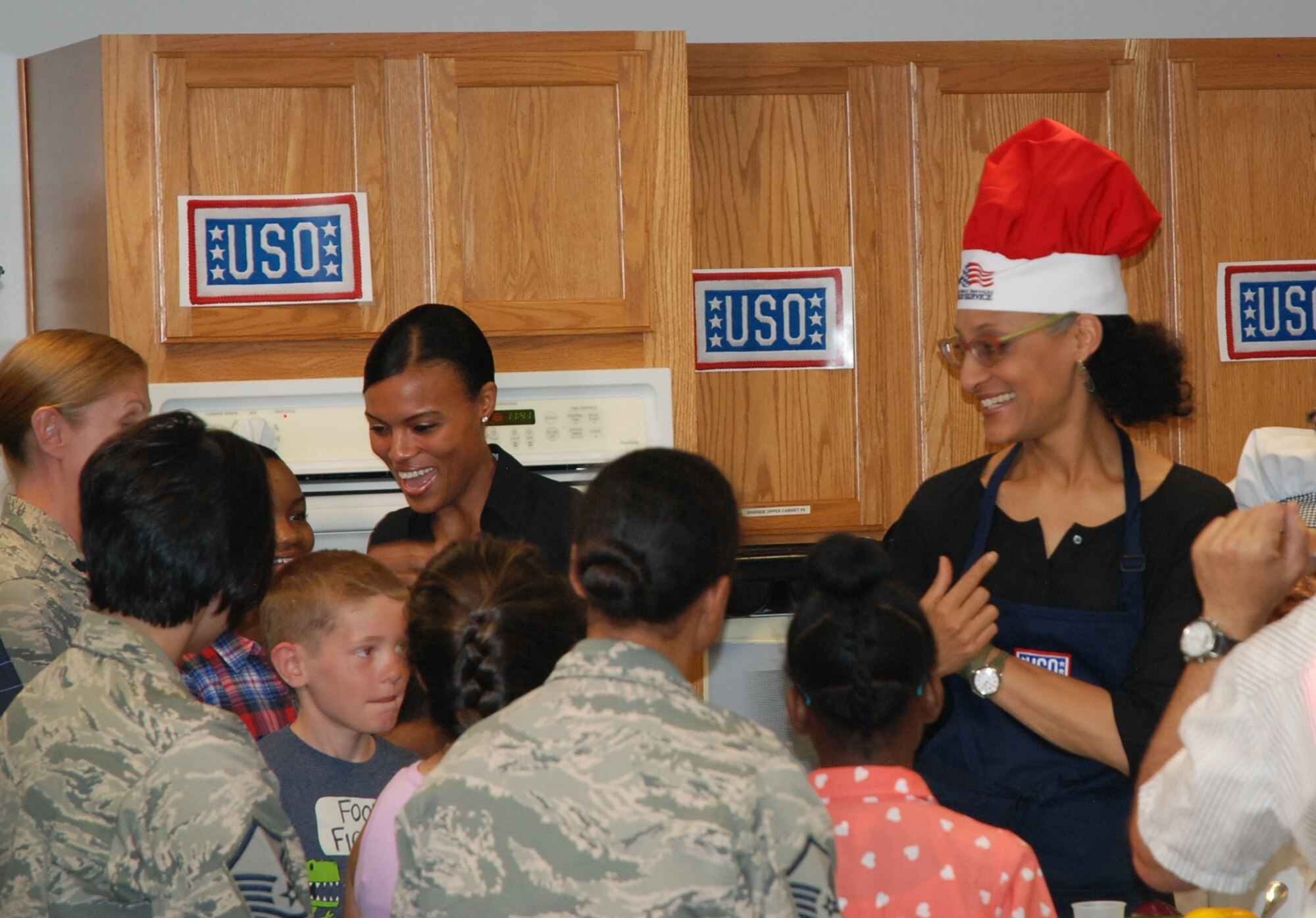 TV chef Carla Hall, co-host of ABCs “The Chew,” is pleased with the answer given by one of the youngsters participating in her cooking class held at the Health and Wellness Center at Peterson Air Force Base on June 22. Hall was on a USO tour of Colorado, also holding similar sessions at Fort Carson and the U.S. Air Force Academy. (U.S. Air Force photo by Dave Smith)