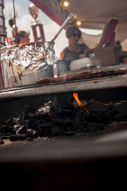 Ribs cook on a grill at the Magic City Ribfest in Minot, N.D., June 19, 2015. A panel of military members judged the ribs on presentation, tenderness and taste. At the end of the day, Col. Jason Armagost, 5th Bomb Wing commander, presented an award on behalf of MAFB to the team with the best tasting ribs.  (U.S. Air Force photo/Airman 1st Class Sahara L. Fales)
