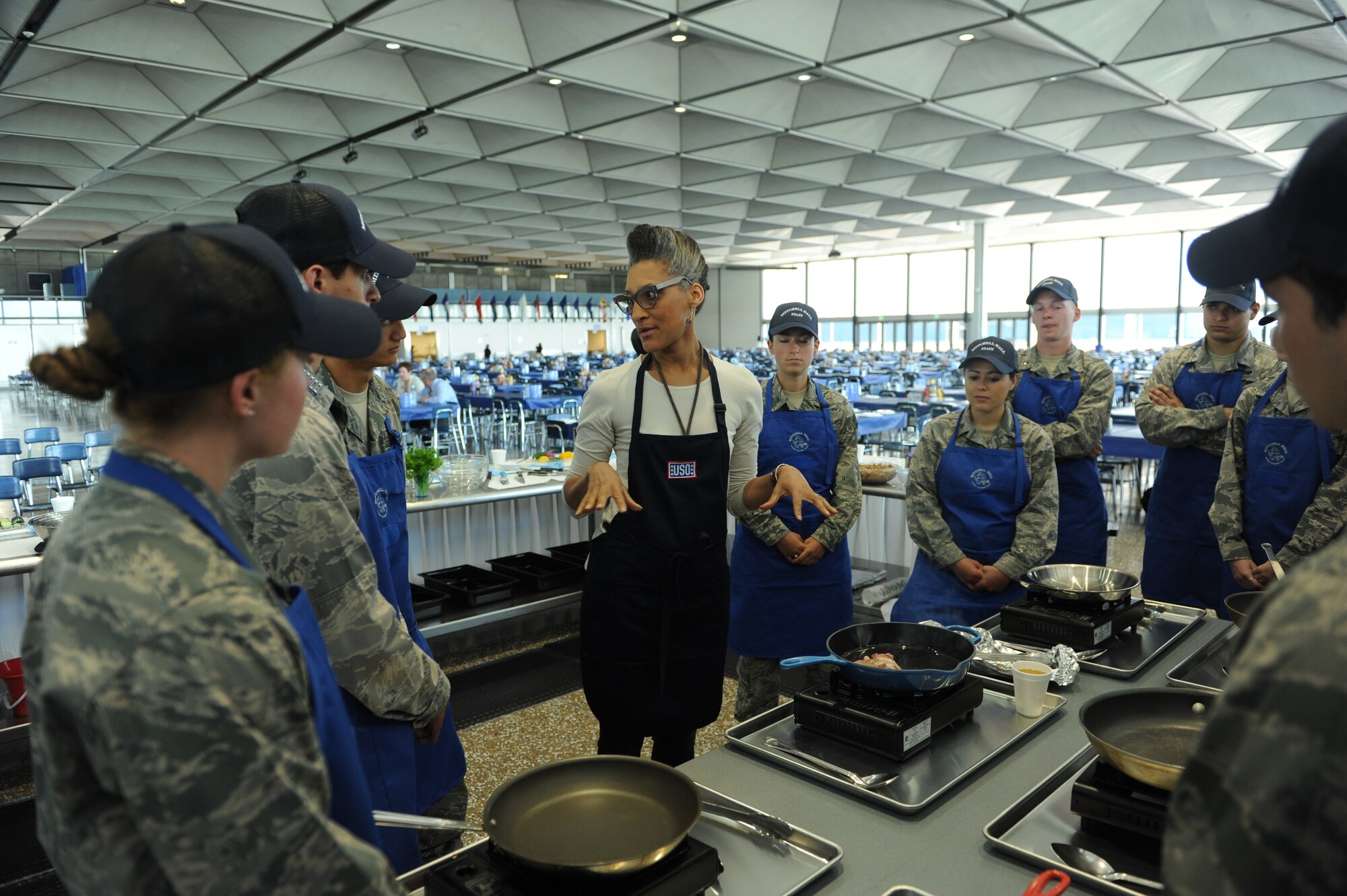 Professional chef and TV cohost of "The Chew" Carla Hall discusses the finer points of searing chicken as part of a recipe-free cooking lesson for U.S. Air Force Academy cadets in Mitchell Hall June 23, 2015. Hall's visit was part of a United Service Organization tour of military bases in the Pikes Peak region. (U.S. Air Force photo/John Van Winkle)  