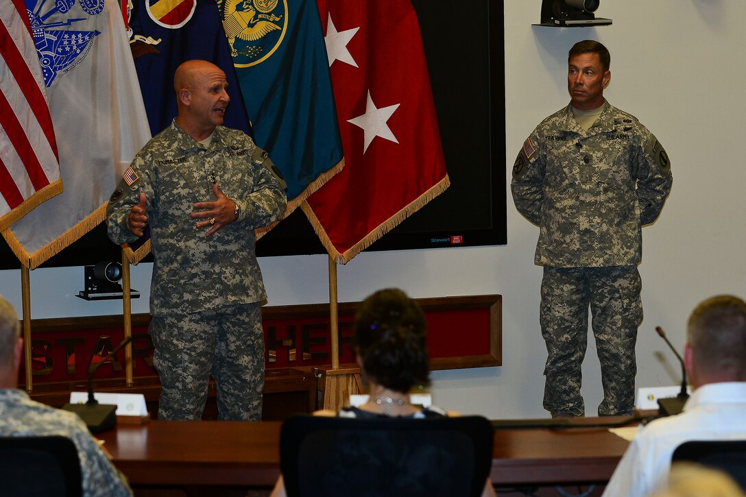 U.S. Army Lt. Gen. H. R. McMaster, Army Capabilities Integration Center director and U.S. Army Training and Doctrine Command deputy commanding general, left, speaks before Sgt. Maj. Stephen Travers, ARCIC incoming command sergeant major, assumes responsibility of ARCIC at Fort Eustis, Va., June 19, 2015. McMaster welcomed Travers, along with his wife to the ARCIC family and said he can’t wait to serve alongside him.  (U.S. Air Force photo by Senior Airman Kimberly Nagle/Released)