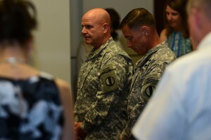 U.S. Army Lt. Gen. H. R. McMaster, Army Capabilities Integration Center director and U.S. Army Training and Doctrine Command deputy commanding general, left, listens to an invocation with Sgt. Maj. Stephen Travers, ARCIC command sergeant major, at Fort Eustis, Va., June 19, 2015. The invocation was read to start the ceremony for Travers, who assumed responsibility as command sergeant major of ARCIC. (U.S. Air Force photo by Senior Airman Kimberly Nagle/Released)