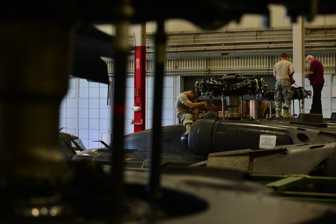 U.S. Army Pvt. Nikkolaus Carr, 128th Aviation Brigade Advanced Individual Training student, works on a UH-60 Blackhawk’s main rotor hub at Fort Eustis, Va., June 18, 2015. Carr was connecting a scissor link, which connects two plates together enabling the aircraft’s blades to rotate.  (U.S. Air Force photo by Staff Sgt. Natasha Stannard/Released)