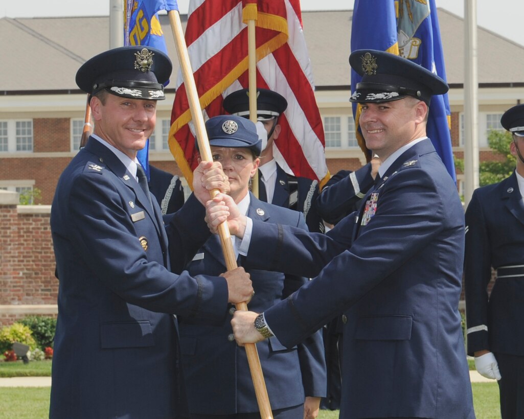 Col. Jon Julian, right, incoming 11th Operations Group commander, accepts the 11 OG guidon from Col. Bradley Hoagland, 11th Wing/Joint Base Andrews commander, during the 11 OG change of command ceremony June 23, 2015, at Joint Base Anacostia-Bolling, District of Columbia. The transfer of the unit guidon symbolizes the transfer of authority from one commander to the next. (U.S. Air Force photo by Senior Airman Preston Webb/RELEASED)