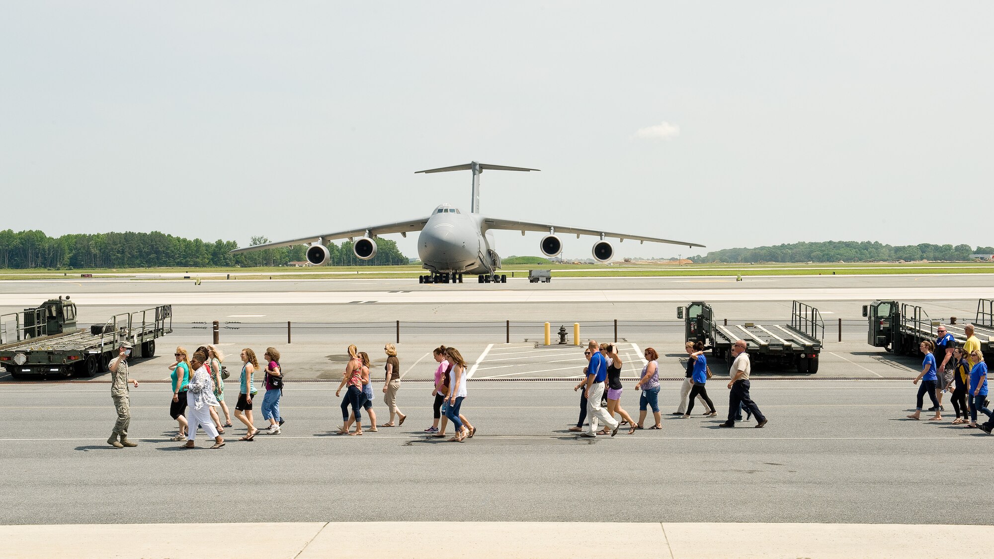 Seventy teachers from George S. Welch Elementary and Dover Air Force Base Middle schools toured Dover Air Force Base, Del., on June 12, 2015. The teachers walked down the flight line side of the 436th Aerial Port Squadron observing numerous cargo loading vehicles and were given a demonstration on the maneuverability capabilities of a K-loader. (U.S. Air Force photo/Roland Balik)