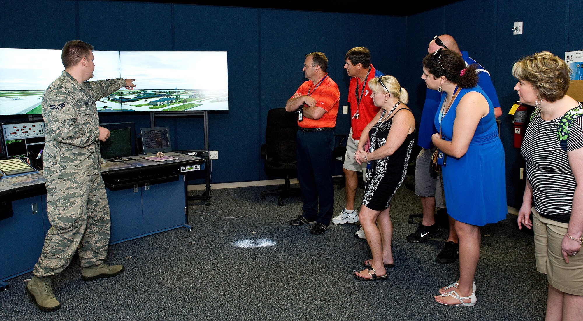 Senior Airmen Brent Sargent, 436th Operations Support Squadron air traffic controller, left, explains the tower simulation system to George S. Welch Elementary and Dover Air Force Base Middle School teachers June 12, 2015, on Dover, Del. The tower simulation system can provide various training scenarios and is also used in upgrade training for tower controllers. (U.S. Air Force photo/Roland Balik)