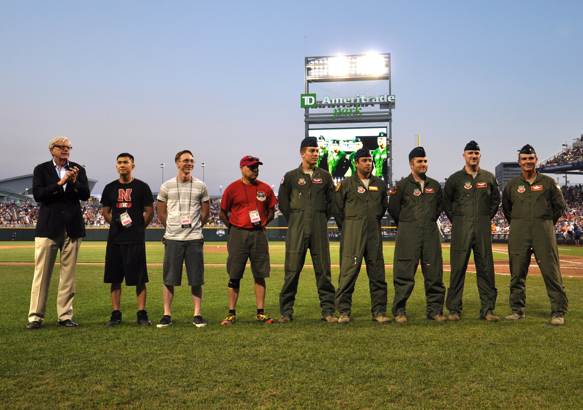 Team Offutt was represented at game one of the College World Series national championship in Omaha, Nebraska as a combined group of 55th Wing active duty and 170th Group Air National Guard members provided a TC-135W flyover of TD Ameritrade Park on Monday, June 22. From left to right, U.S. Air Force Senior Airman Thanh Chu, 55th Communications Squadron, U.S. Air Force Airman 1st Class Patrick Elledge, 55th CS, U.S. Air Force Master Sgt. Mario Mendez, 618th  Air Operations Center, U.S. Air Force Capt. Trebor Cowlling, 343rd Reconnaissance Squadron, U.S. Air Force Maj. Joseph Quillin, 55th Operations Support Squadron, U.S. Air Force Capt. Bryan Allebone, 238th Combat Training Squadron, U.S. Air Force Capt. Ryan McGrail, 238th CTS, and U.S. Air Force Lt. Col. John O’Neill, 38th Reconnaissance Squadron, were all recognized on the field along with Rep. Brad Ashford, far left, in between the sixth inning. (U.S. Air Force photo by Ryan Hansen/Approved)