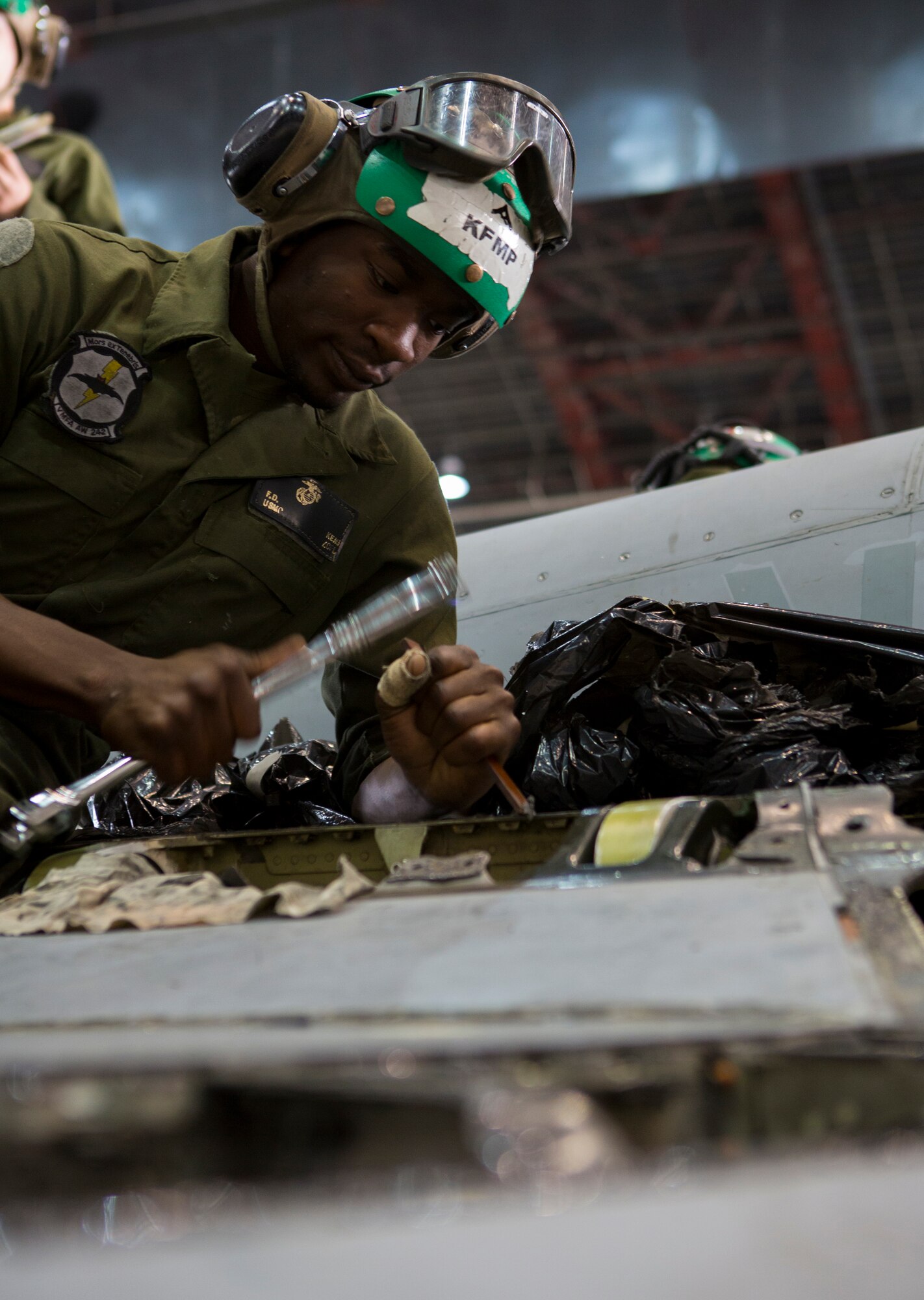 U.S. Marine Corps Lance Cpl. Floydrick D. Kemp, an airframes mechanic with the Marine All-Weather Fighter Attack Squadron (VMFA [AW]) 242, 1st Marine Aircraft Wing, removes old sealant on a U.S. Marine Corps FA-18D Hornet assigned to VMFA (AW)-242 during Exercise Northern Edge 15 at Eielson Air Force Base, Alaska, June 22, 2015. Northern Edge is Alaska’s premier joint training exercise designed to practice operations, techniques and procedures as well as enhance interoperability among the services. Thousands of service members from active duty, reserve and National Guard units are involved. (U.S. Marine Corps photo by MCIPAC Combat Camera, Cpl. Suzanne Dickson/Released)
