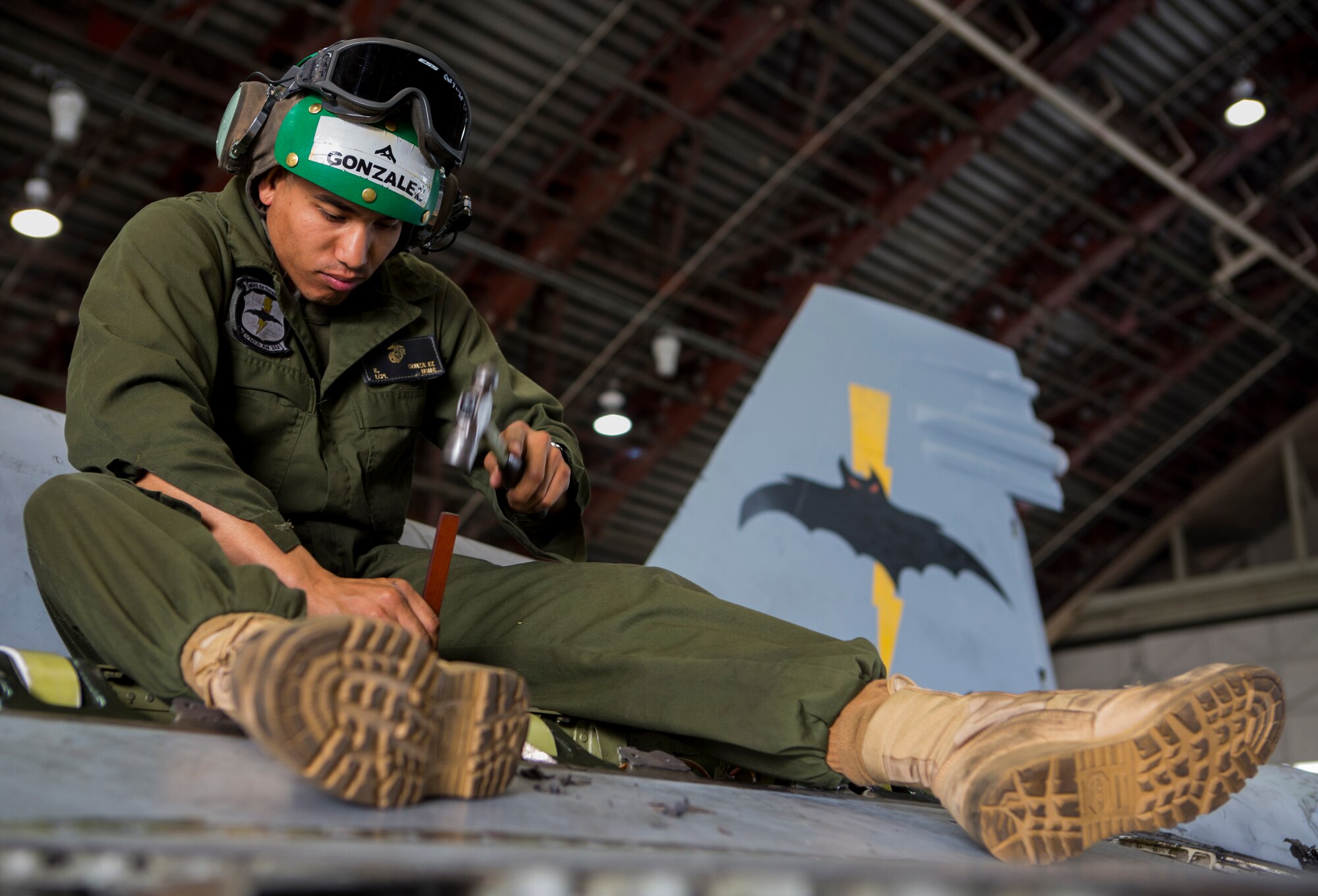 U.S. Marine Corps Lance Cpl. Emanuel Gonzalez, an airframes mechanic with the Marine All-Weather Fighter Attack Squadron (VMFA [AW]) 242, 1st Marine Aircraft Wing, removes old sealant on a U.S. Marine Corps FA-18D Hornet assigned to VMFA (AW)-242 during Exercise Northern Edge 15 at Eielson Air Force Base, Alaska, June 22, 2015. Northern Edge is Alaska’s premier joint training exercise designed to practice operations, techniques and procedures as well as enhance interoperability among the services. Thousands of service members from active duty, reserve and National Guard units are involved. (U.S. Marine Corps photo by MCIPAC Combat Camera Cpl. Suzanne Dickson/Released)