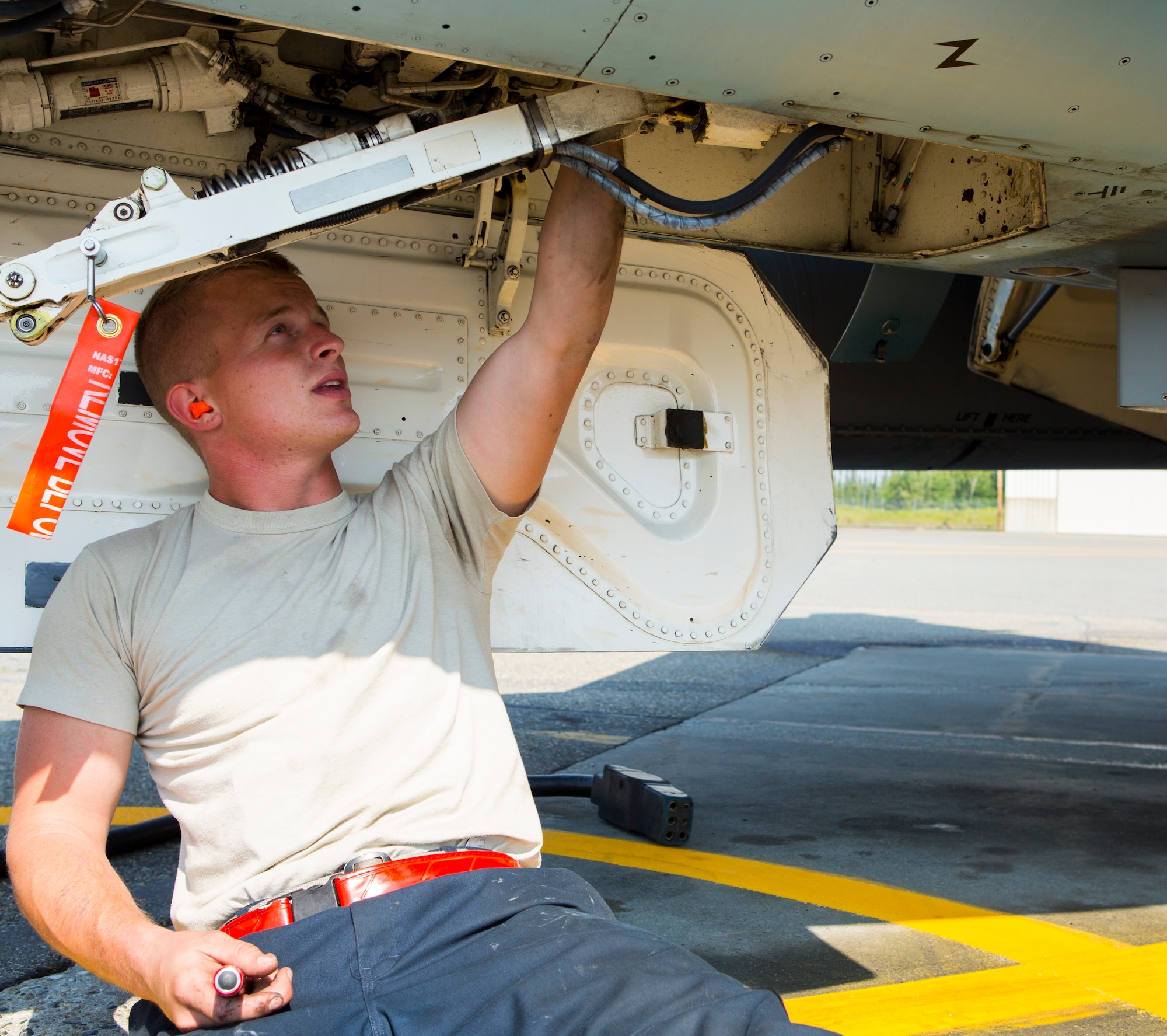 U.S. Air Force Senior Airman Dylan J. Gagne, a crew chief with the 18th Aggressor Squadron, works on an F-16C Fighting Falcon aircraft during Exercise Northern Edge 15 at Eielson Air Force Base, Alaska, June 19, 2015. Northern Edge is Alaska’s premier joint training exercise designed to practice operations, techniques and procedures as well as enhance interoperability among the services. Thousands of service members from active duty, reserve and National Guard units are involved. (U.S. Marine Corps photo by Cpl. Suzanne Dickson/Released)