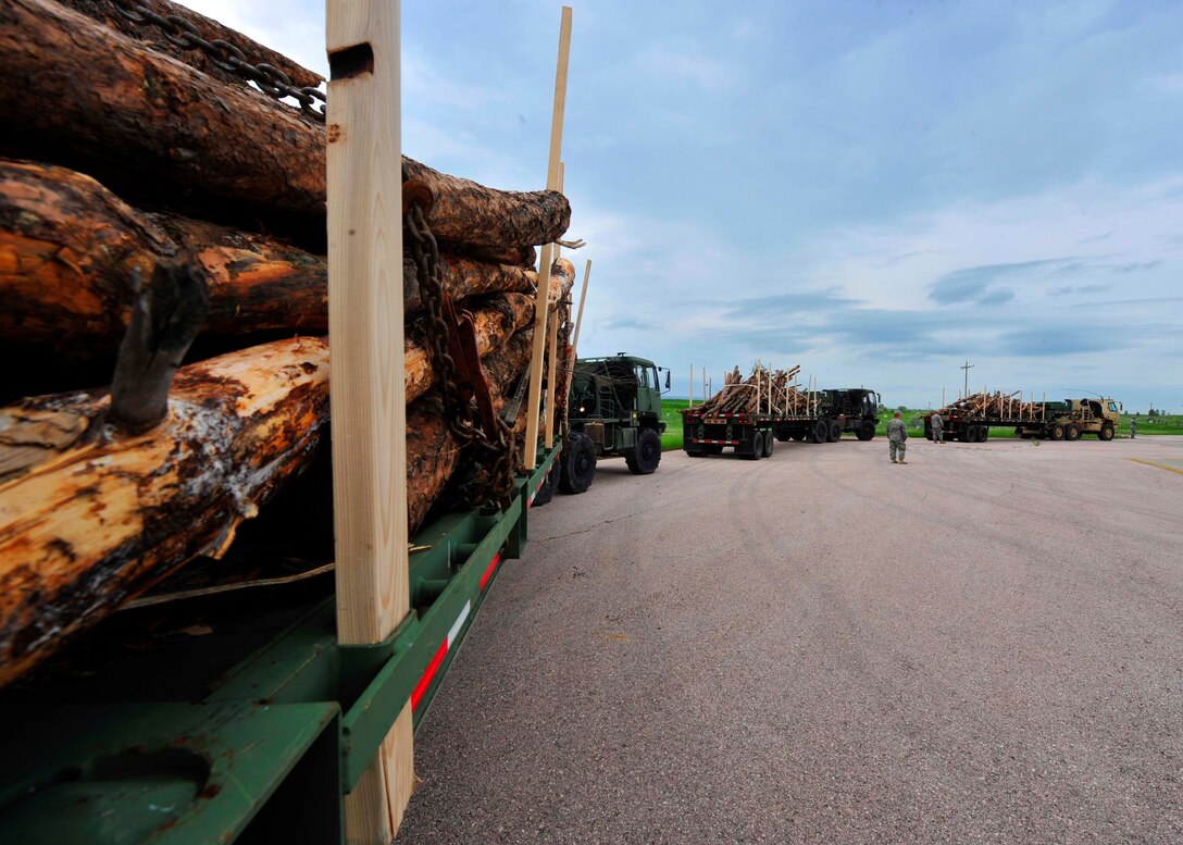 Tractor trucks belonging to the 1344th Transportation Company, hauls lumber in support of Golden Coyote at Ellsworth Air Force Base, S.D., June 10, 2015. Soldiers provided lumber to members of the local community for use as firewood after clearing it from the surrounding area to help prevent forest fires. (U.S. Air Force Photo by Airman 1st Class James L. Miller/Released)