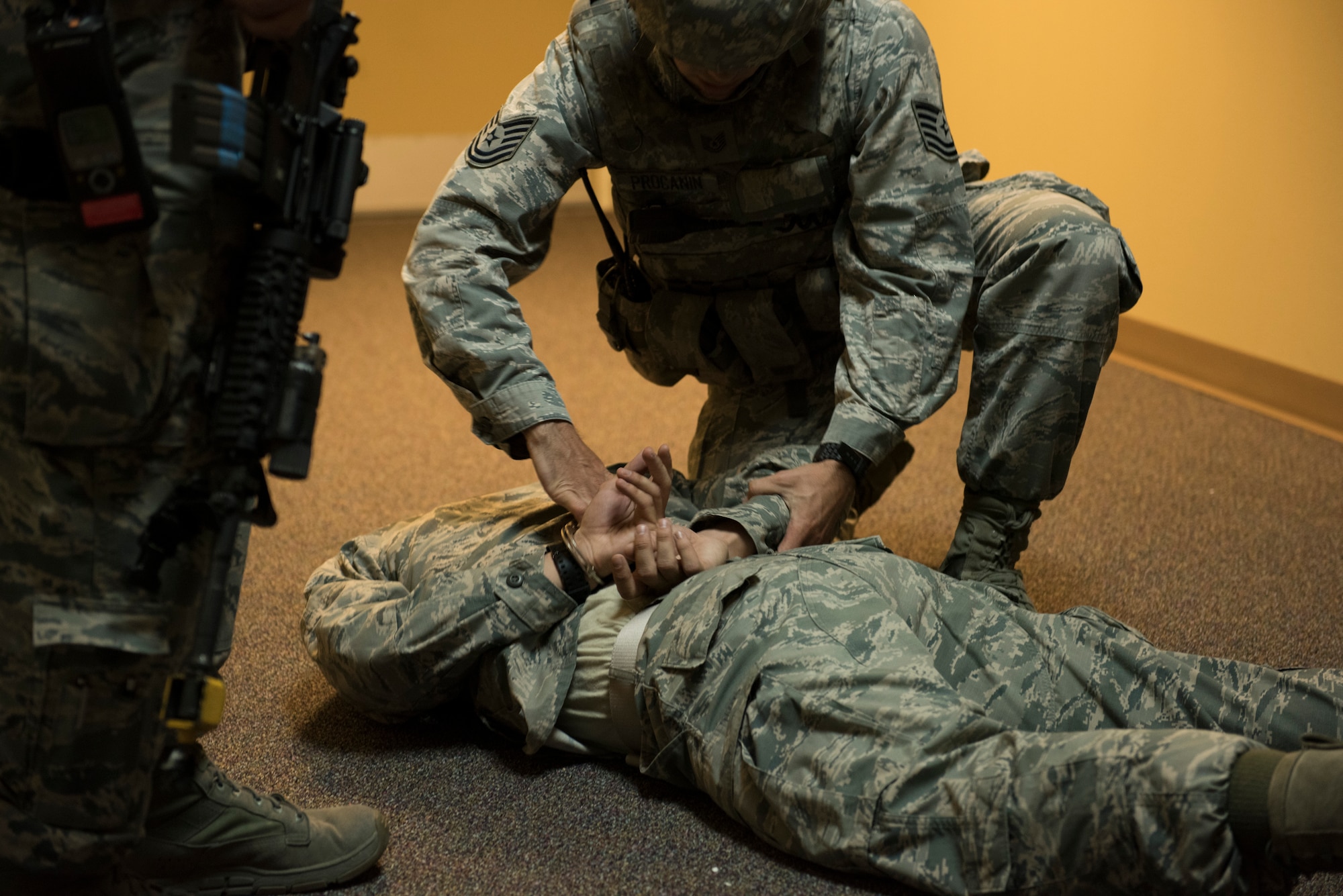 366th Security Forces Squadron members handcuff the active shooter during the exercise June 18, 2015, at Mountain Home Air Force Base, Idaho. Once the role played active shooter was apprehended, Security Forces performed a sweep to ensure the area was safe.(U.S. Air Force photo by Airman 1st Class Jeremy L. Mosier/RELEASED)