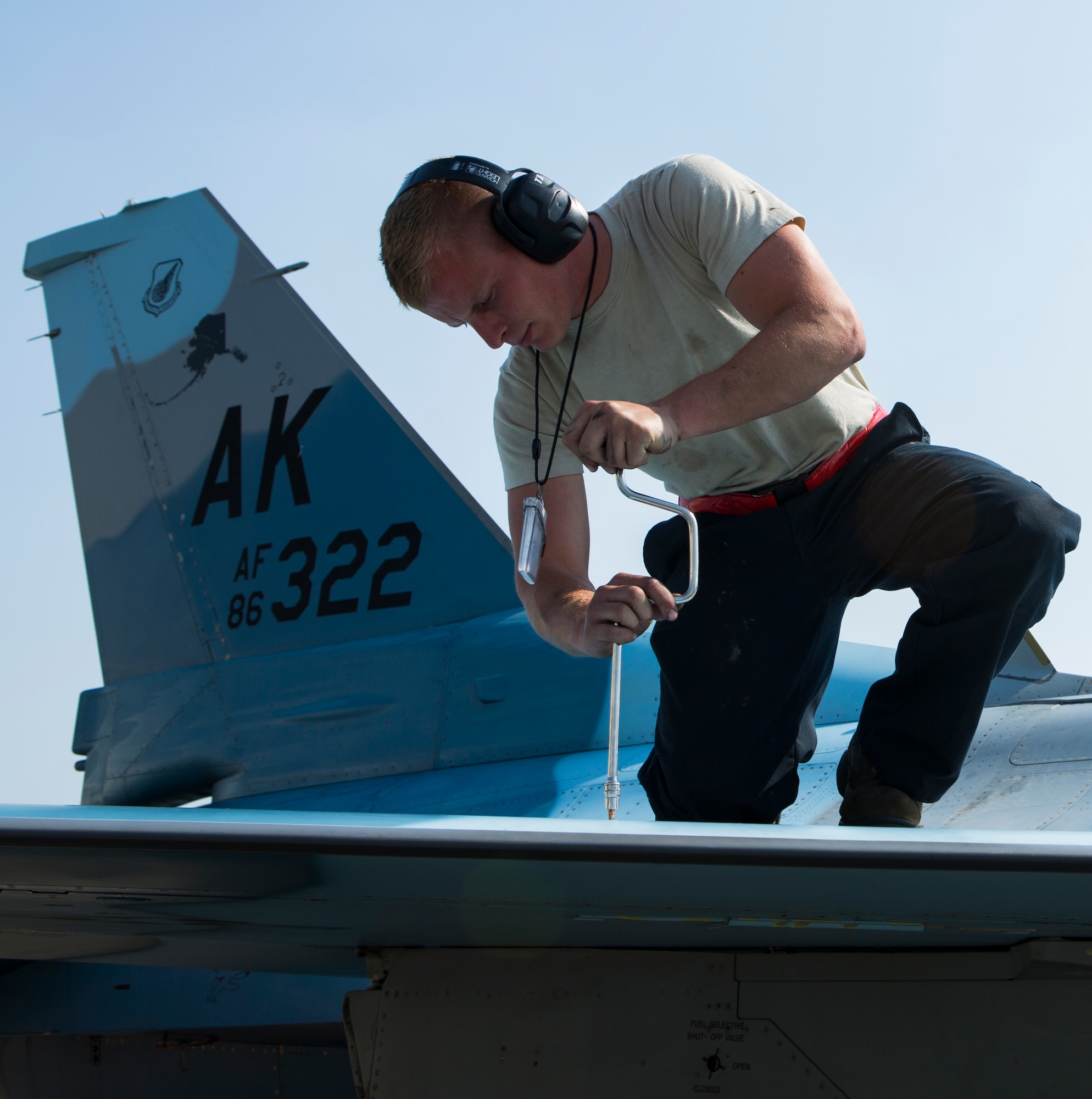 U.S. Air Force Senior Airman Dylan J. Gagne, a crew chief with the 18th Aggressor Squadron, works on a F-16C Fighting Falcon aircraft during Exercise Northern Edge 15 at Eielson Air Force Base, Alaska, June 19, 2015. Northern Edge is Alaska’s premier joint training exercise designed to practice operations, techniques and procedures as well as enhance interoperability among the services. Thousands of service members from active duty, reserve and National Guard units are involved. (U.S. Marine Corps photo by MCIPAC Combat Camera, Cpl. Suzanne Dickson/Released)