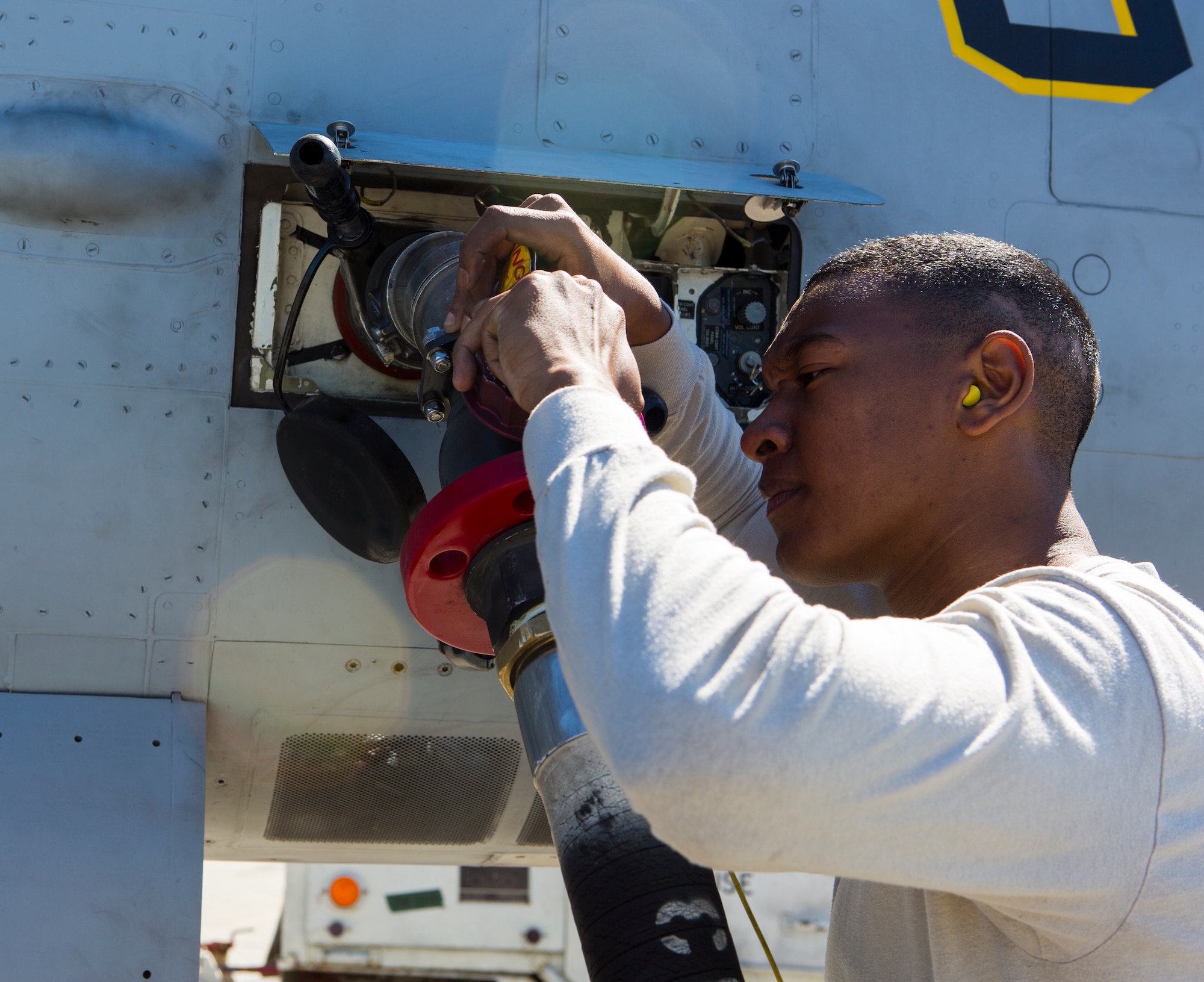 U.S. Air Force Airman 1st Class Anthony Jackson, 18th Logistics Readiness Squadron, fuel distribution operator, checks the fuel hose connected to a U.S. Marine Corps FA-18 D Hornet during Exercise Northern Edge 15 at Eielson Air Force Base, Alaska, June 18, 2015. Northern Edge is Alaska’s premier joint training exercise designed to practice operations, techniques and procedures as well as enhance interoperability among the services. Thousands of Airmen, Soldiers, Sailors, Marines and Coast Guardsmen from active duty, Reserve and National Guard units are involved. (U.S. Marine Corps photo by Cpl. Suzanne Dickson/Released)